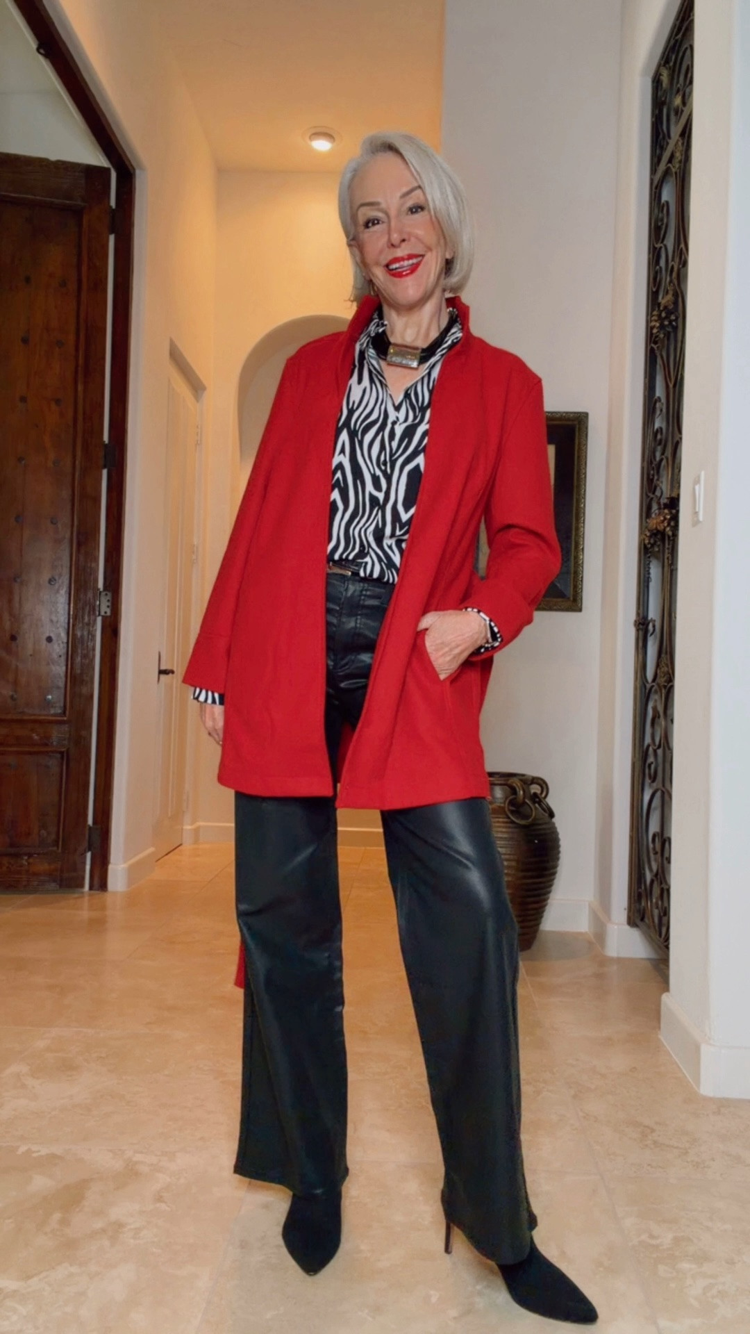 Melton red wool self belt coat worn multiple ways. With leopard, zebra, over a LBD, red on red. 
Bold accessories, and faux leather pants

#LTKOver40 #LTKWorkwear #LTKgrwm