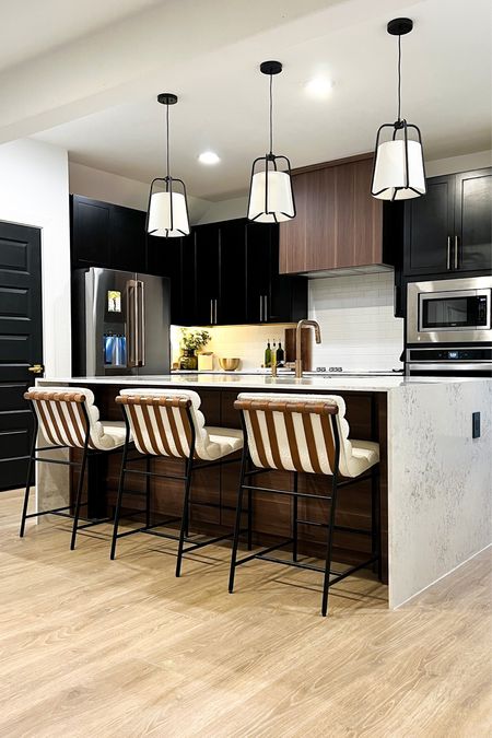 I’m obsessed with our organic modern kitchen! The boucle barstools, walnut accents, and gold hardware compliment the black cabinets so nicely!

#LTKFind #LTKunder100 #LTKhome