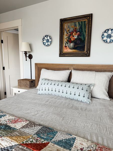 Bedroom decor - patchwork quilt, floral bolster pillow, ticking stripe shams, plug in wall sconce light, blue white plate on wall 

#LTKstyletip #LTKSeasonal #LTKhome