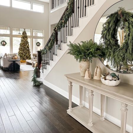 Entryway Christmas views! The theme and vibe of my Christmas decor is all about the lush greenery! My McGee and co wreath is sold out but I linked a dupe! And I linked some garland options for you! My king of Christmas tree is gorgeous and comes in different sizes. Mine is 10’ tall. #christmasdecor #entrywaydecor #christmasentryway

#LTKSeasonal #LTKstyletip #LTKhome