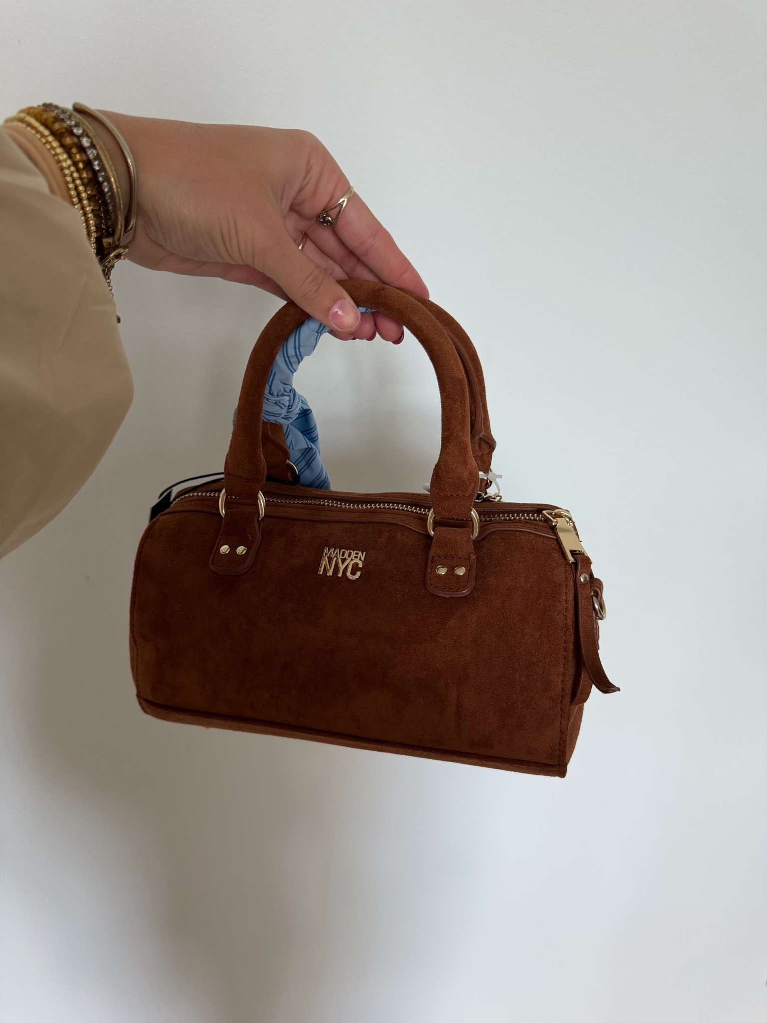 The Madde NYC Small Top Zip Faux Suede Handbag—crafted in a soft faux suede for a chic look, this baguette-silhouette handbag tucks neatly under your arm like it’s meant to be there. Running late? Clip on the crossbody strap and go hands-free? Feeling stylish? Add the scarf, let the keychains swing, and your look is now complete. With a top zip to secure the essentials, this handbag is a versatile choice for any type of day.

#LTKootd #LTKSeasonal #LTKdayinmylife