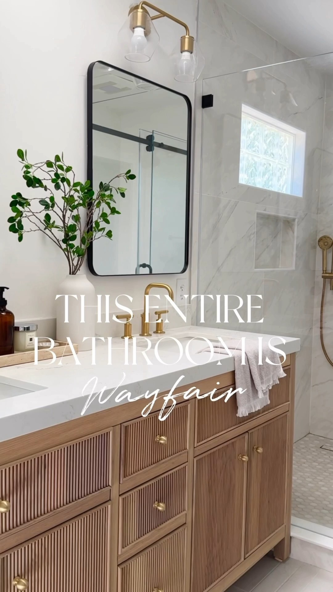 This entire beautiful bathroom is from Wayfair. We used so many affordable options, yet were able to achieve this high-end look. Love the reeded detail of this prefab wood vanity, which comes with multiple different countertop options. My favorite part could be the medicine cabinet. So stylish and functional. Love how the neutral colors of the tile provide a serene vibe.

Marble tile, large format, tile, gray tile, wood, vanity, brass faucet, brass shower system, black rectangle, mirror, medicine cabinet glass, sconces, brass, sconces, glass, shower door, sliding glass door

#LTKHome #LTKOver40 #LTKSaleAlert