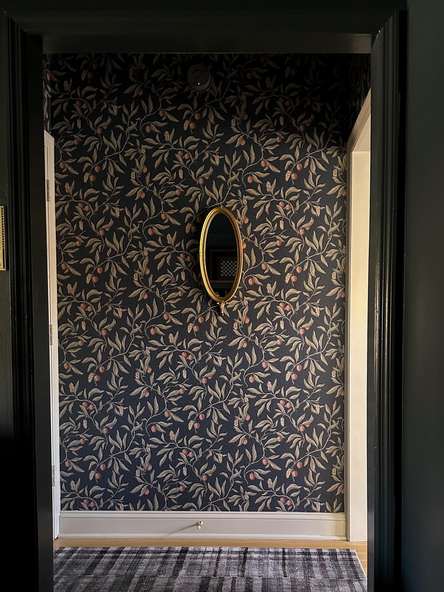 Small spaces can be the most important connectors in a home.

I shopped my house this weekend and finally moved this little cutie of a mirror into the back entry. It was a Facebook Marketplace find from a couple years ago, and I’ve styled it in a few different rooms since but I can’t believe it took me this long to realize it belonged here. The shape, the scale, that tiny finial at the base… it’s so unique!

This back entry is a small corner of the house, but it plays an important role. It bridges the gap between the cozy TV room and the kitchen, and when I designed it, it felt a little risky. I knew I’d eventually want to renovate the kitchen, but that timeline was very fuzzy. My goal was for this space to act as a true connector. Something that felt cohesive no matter what happened on either side.

This year, I’d love to add crown molding now that I know how to do it (dangerous knowledge), and I may repaint the trim to match the kitchen cabinets exactly. It’s close right now but different enough to bother my Type A brain just a bit. 😅

Swipe to see how far this space has come →

#beforeandafters #wallpaperideas #smallspaces #interiordesign #secondhandstyle