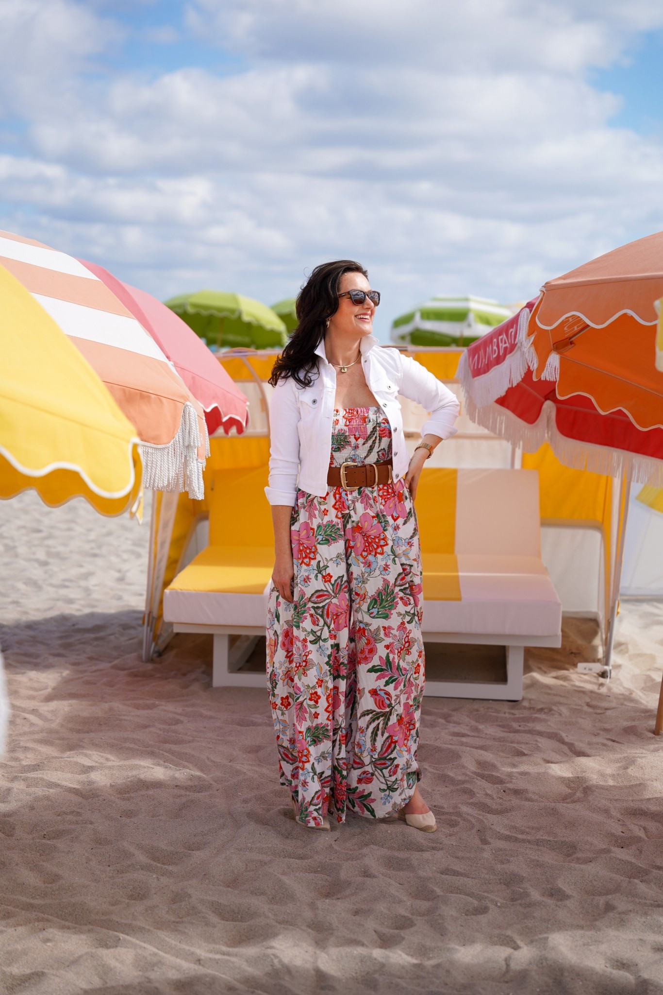 Planning a warm weather spring vacation to Miami, Los Angeles, or Palm Springs? Here’s an easy spring vacation outfit featuring a colorful floral jumpsuit styled with a classic white jean jacket, espadrilles, and a statement belt. This effortless spring look is perfect for beach vacations, warm-weather travel, resort days, and casual sightseeing. Floral jumpsuits paired with denim jackets create a chic yet comfortable outfit ideal for spring trips, coastal getaways, and relaxed everyday style. 

#LTKootd #LTKTravel #LTKSeasonal