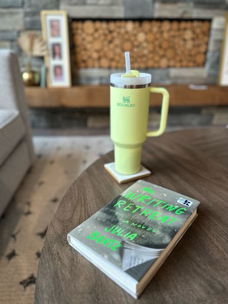 Green Stanley water bottle and thriller I’m currently reading 
Books 