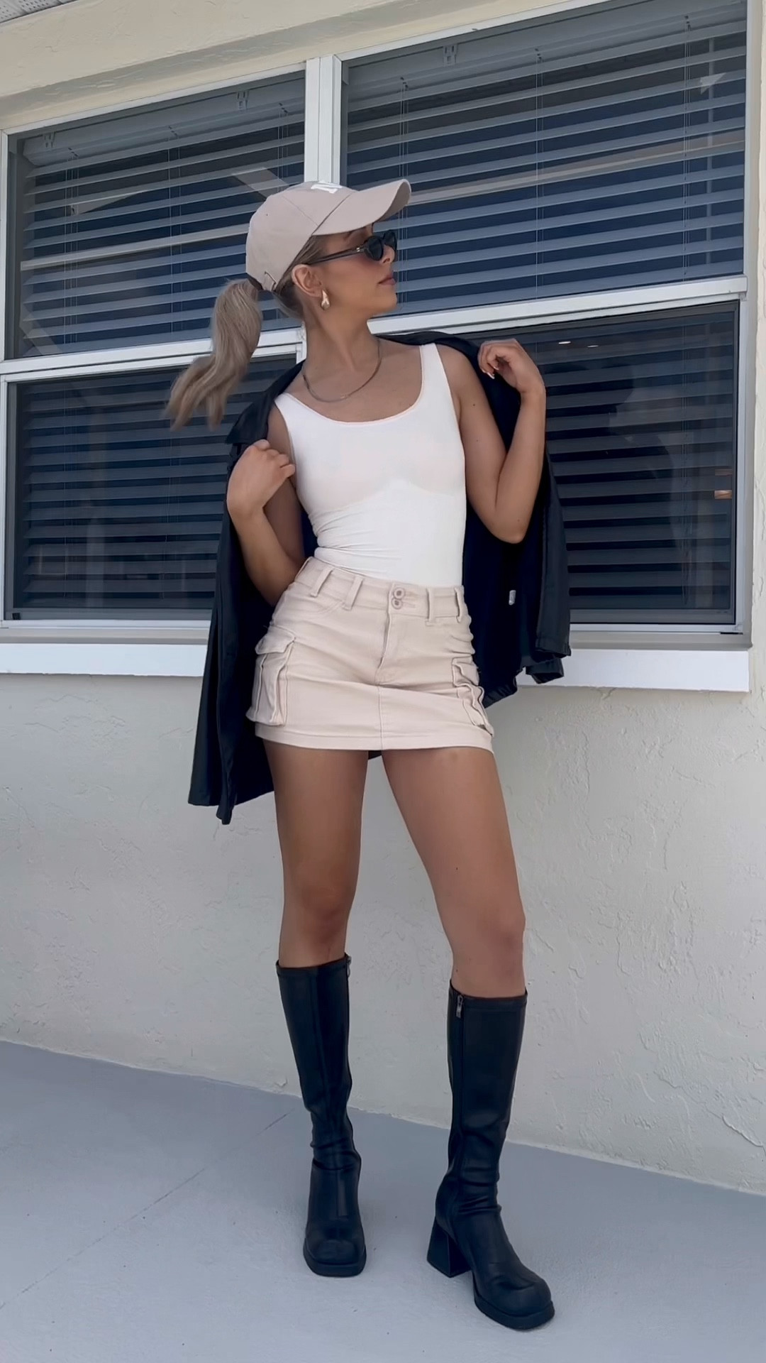 Cargo mini skirt, cream bodysuit, chunky black knee high boots, black oval retro sunglasses, beige NY hat, black leather blazer, fall outfits for Florida, trending fall fashion 2023

#LTKVideo #LTKxPrime #LTKHolidaySale