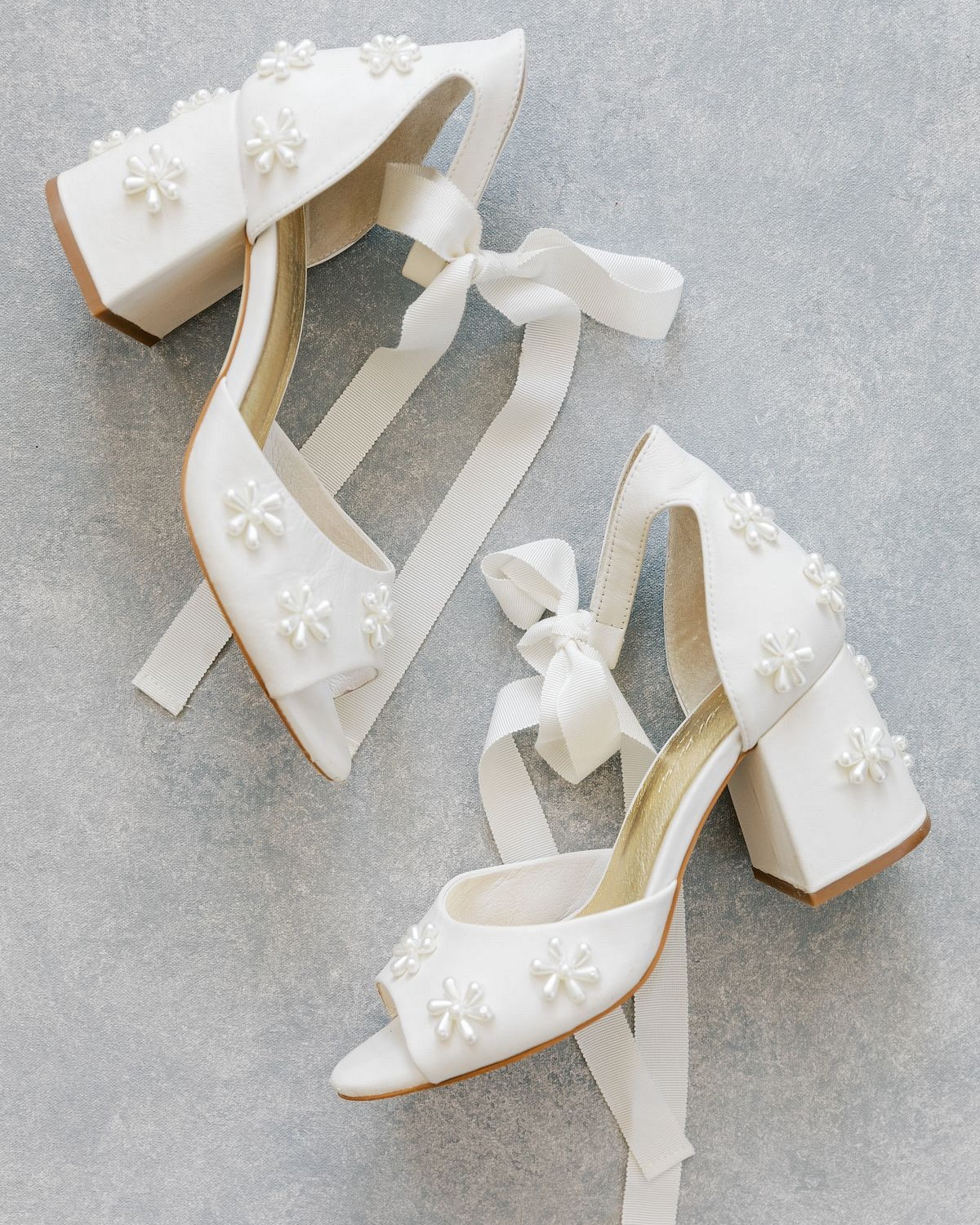 If your dream bridal look is classic elegance, you can't go wrong with pearl wedding shoes. Typically ivory in color, pearl shoes will tone beautifully with your wedding dress while providing a touch of grace and style.

We love that pearls symbolize purity, wisdom, and spiritual transformation. Plus, the round shape of pearls is often linked to the moon, which is believed to have feminine energy associated with nurturing and motherhood. Feeling inspired? Discover our edit of the best pearl bridal shoes to shimmer and shine on your big day.


#LTKShoeCrush #LTKWedding #LTKParties