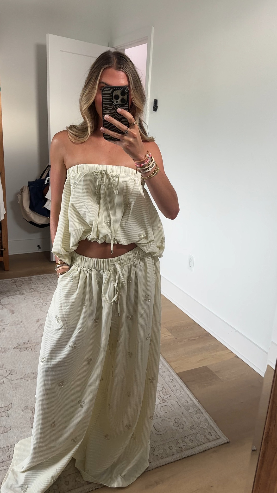 Beige striped strapless poplin blouse designed for sweet summer styling, brunch looks, and casual everyday wear. Crafted from a beige and white striped poplin material, this breezy blouse features an elasticized strapless neckline with adjustable drawstrings, a relaxed fit with gathered detailing, an elasticized hem, and a subtle high-low silhouette. Style with the coordinating AKIRA Label Light and Airy Poplin Pant for a chic matching look. @shopakira

#LTKootd #LTKSeasonal #LTKdayinmylife
