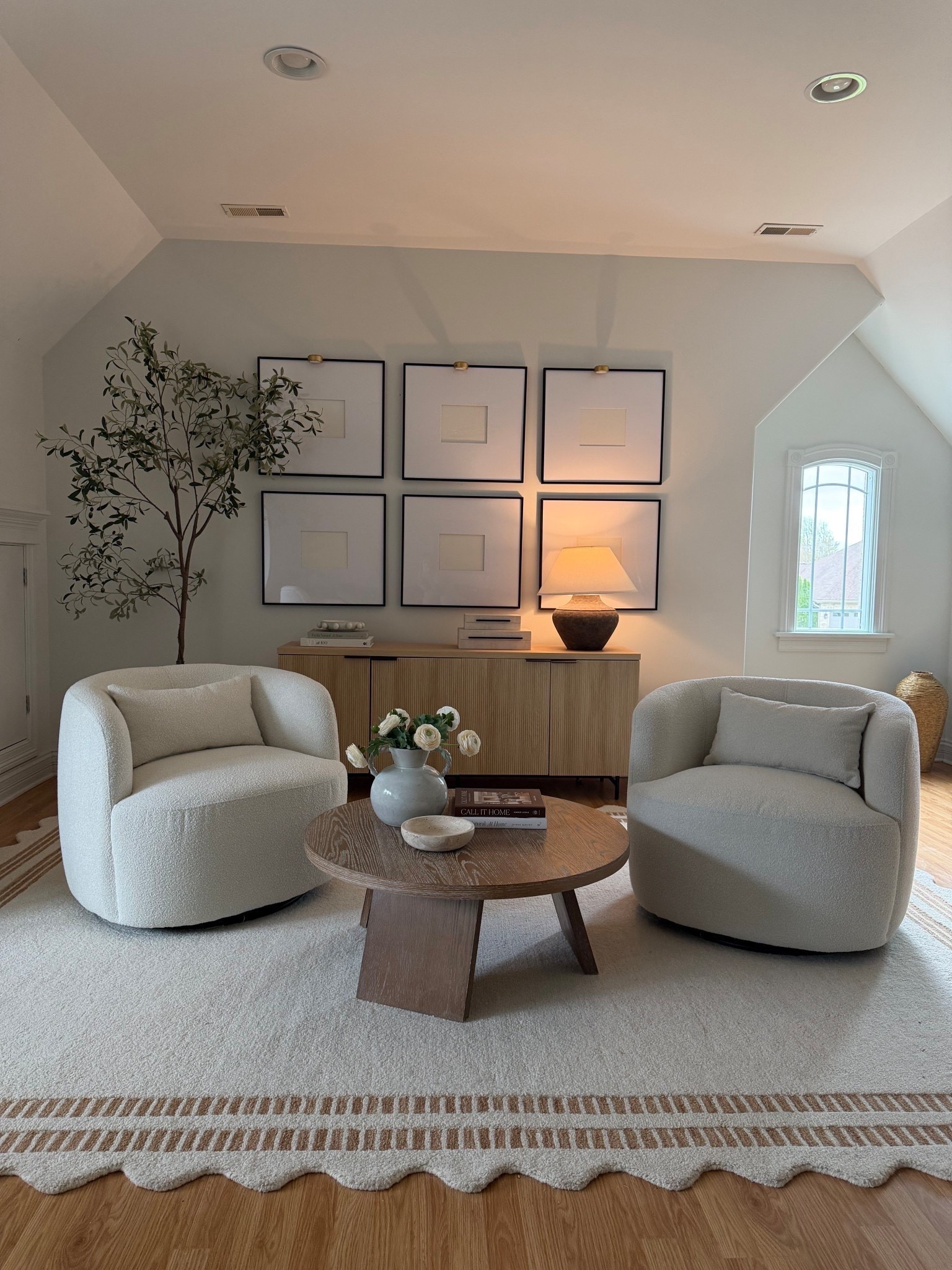 One of my favorite corners in our home. The swivel chairs, fluted sideboard, rechargeable picture lights, and styling pieces create such a peaceful space. Shop everything linked here.

#LTKHome #LTKSaleAlert