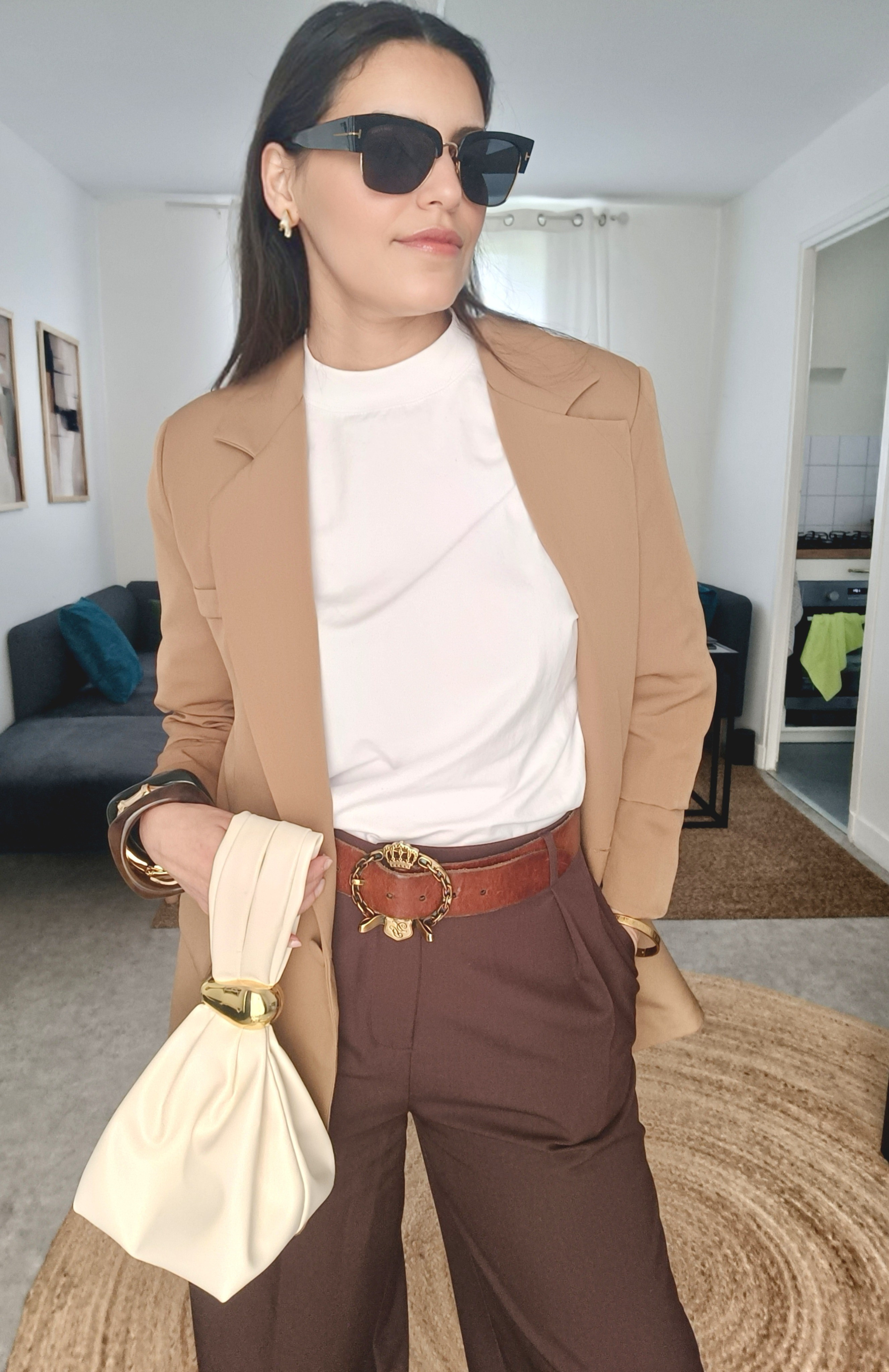 Effortless neutral chic 🤎✨If you’re building a timeless wardrobe, this is the kind of outfit you need. Clean, elegant, and easy to recreate.I paired a structured camel blazer with a soft cream high-neck top for that polished minimal vibe. The chocolate brown tailored trousers add depth and instantly elevate the look 🤎Accessories make all the difference:– Gold statement belt for a luxe touch ✨– Sculptural ivory bag for contrast– Oversized sunglasses for that confident, effortless finish 🕶️This is your go-to outfit for:✔️ Work meetings✔️ Lunch dates✔️ Everyday chic stylingNeutral tones = maximum versatility. You can mix & match every piece endlessly 🔁Shop the look below 👇#ltkstyle #ltkworkwear #neutraloutfit #capsulewardrobe #minimalstyle #elegantoutfit #fallstyle #chiclook #outfitinspo #wardrobeessentials 🤍

#LTKfrance #LTKeurope #LTKsummer