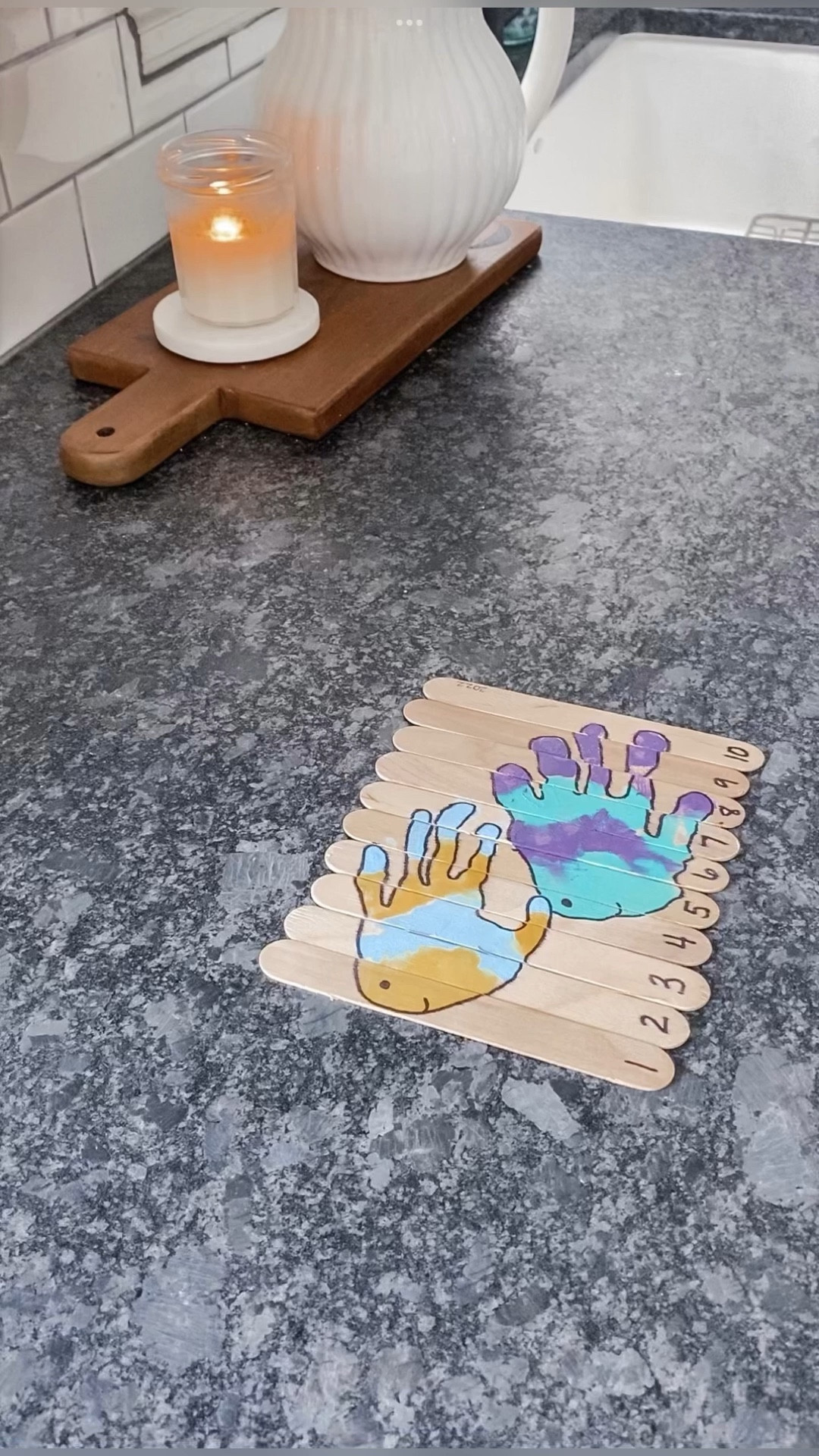 FISH HANDPRINT POPSICLE STICK KEEPSAKE PUZZLE! 🐠 

Crafting memories, one handprint at a time! ✋ Dive into a seasonal kids' craft activity with your preschoolers and create the Keepsake Popsicle Stick Puzzle! 🧩 

You guys know I'm a complete sucker for handprints! Stamp your child's sweet handprints on a line of 10 popsicle sticks, transforming them into a heartwarming picture. Then, number the sticks 1-10 and let the excitement begin as your child mixes up the order and skillfully puts the puzzle back together! 🙌🔢 

Watch their faces light up as they learn number ordering, counting, and create a treasured handprint keepsake. ✨ 

#LTKFind #LTKSeasonal #LTKkids