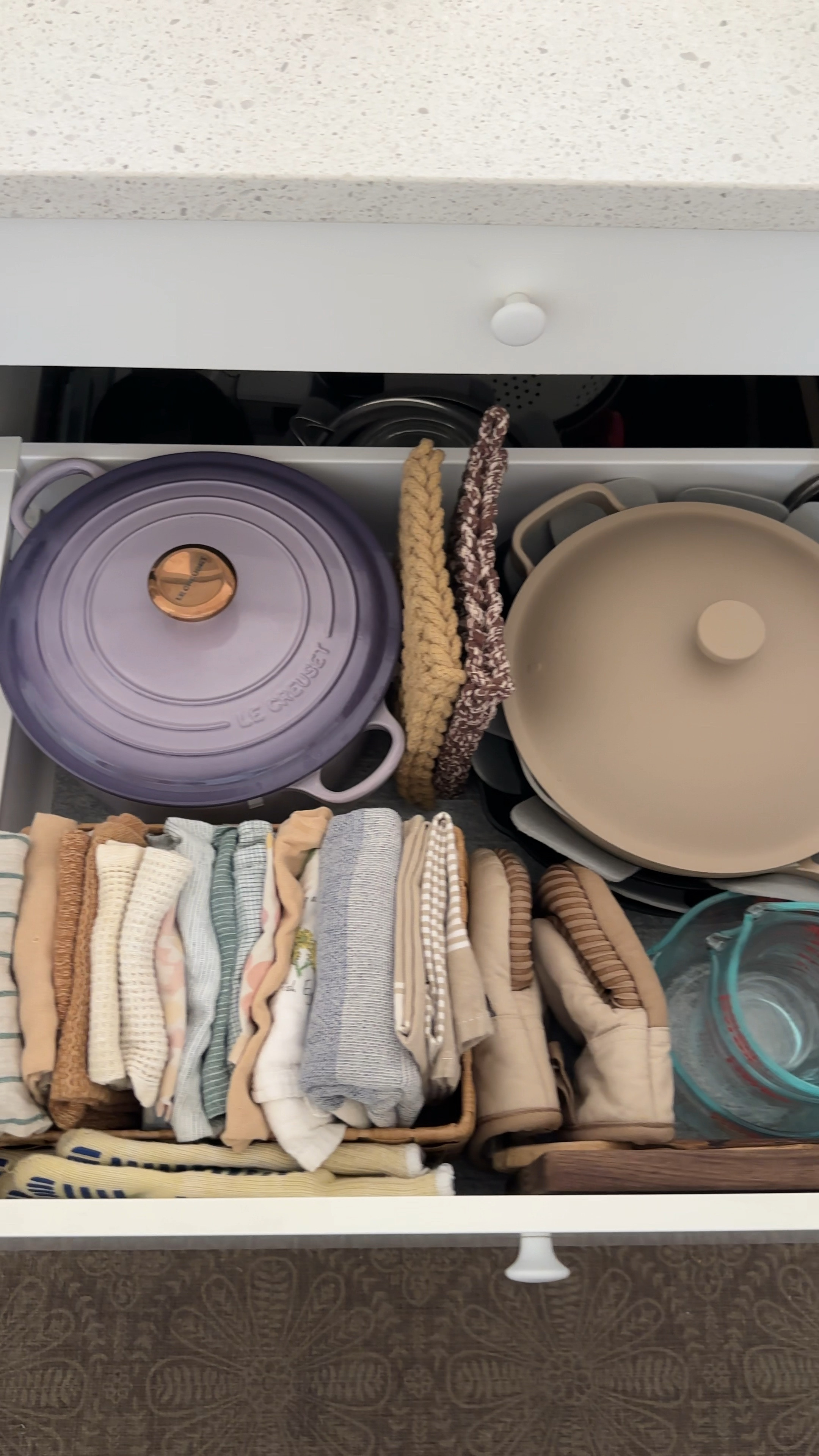 The satisfaction of an organized kitchen drawer! My cooking drawer is refreshed to neatly hold my Le Creuset Dutch Oven in the color “Provence” , many tea towels, Our Place Always Pan, and cast iron Lodge skillets separated by felt liners. I also keep my Pyrex measuring cups and my kitchenaid hand mixer in here too. I jave just enough room to hold everything I need to cook. #organized #kitchendrawer #organization 

#LTKVideo #LTKHome