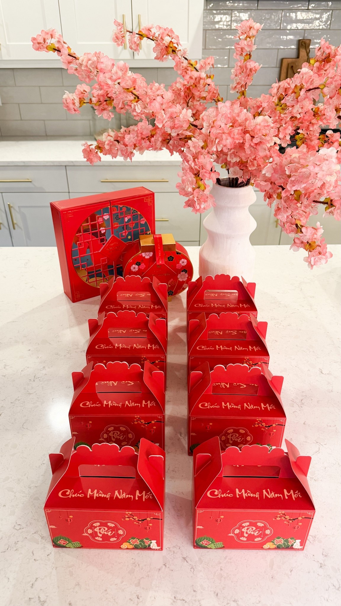 Lunar New Year party favor idea for kids!

Tết favor boxes, cherry blossom branches, Sugarfina LNY candy box, gold chocolate coins 