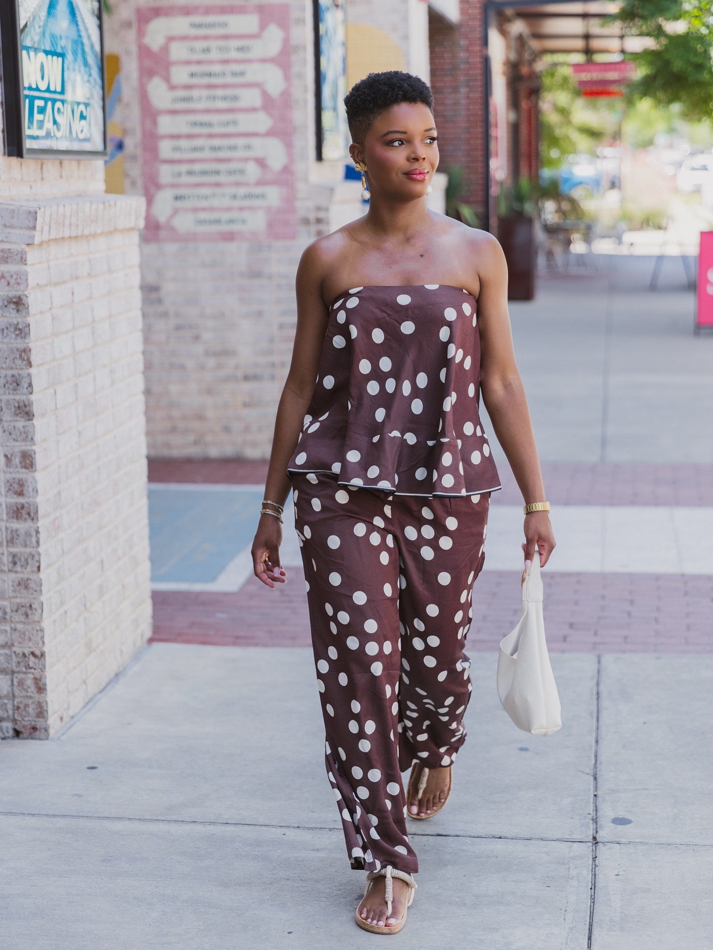 #AnthroPartner Monday mood: dressed up, sun-kissed, and soaking in the joy of slow moments ☀️✨

Wearing the @anthropologie Strapless Swingy Scarf Top paired with the effortlessly chic Brooklin Printed Wide-Leg Pants and finished with the playful charm of the Love Knot Slouchy Bag: Mini Buckle Edition.

Because getting dressed isn’t just about clothes—it’s about how it makes you feel. Here’s to embracing the sunshine, exploring with ease, and letting style reflect the joy within. 🌿💛 #Anthro #Anthropologie #myanthropologie