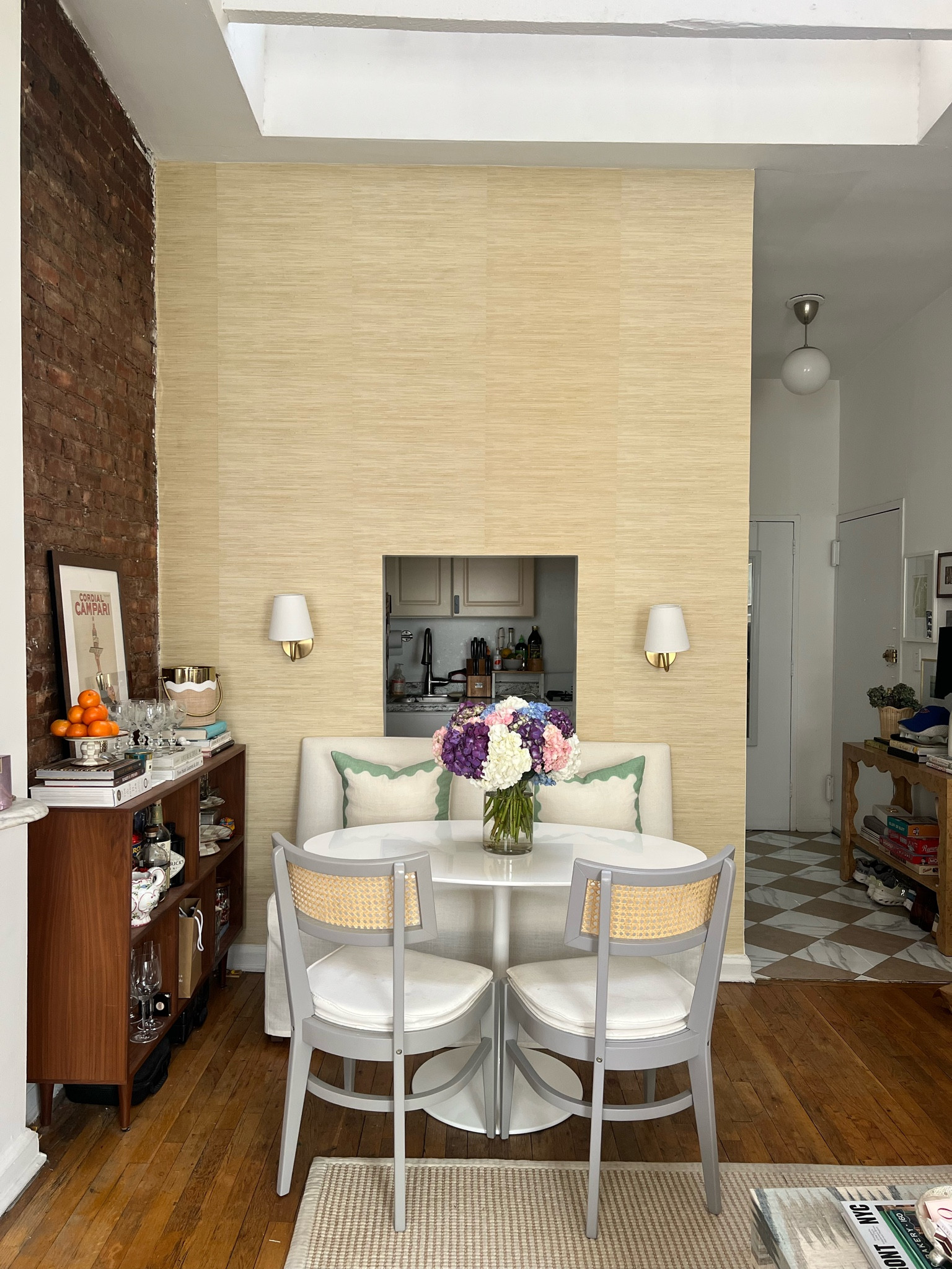 Our dining area 🤍 linking our renter-friendly sconces, peel and stick wallpaper, similar pillows, perfect oval dining table, chairs, peel and stick floor tiles, and a few of our bar accessories! 

The bar cabinet was a Facebook marketplace find

The banquette is linked on my IG apt highlight 

#LTKHome #LTKFindsUnder100