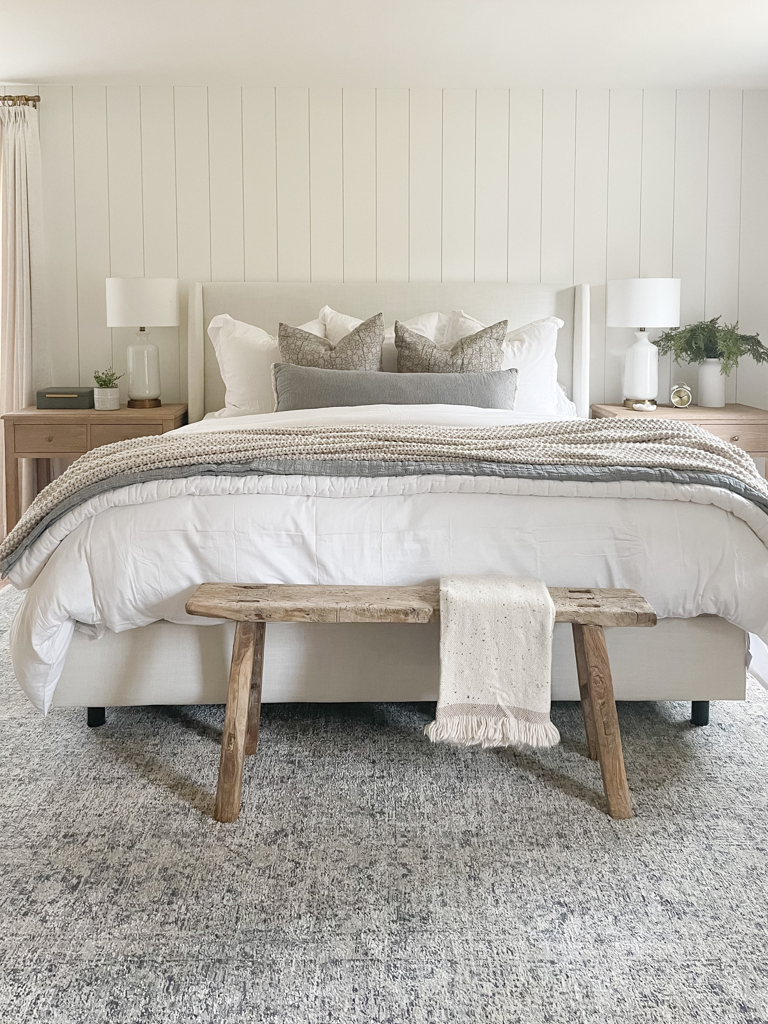 Modern coastal bedroom l, Loloi rug, upholstered bed, nightstands, wood bench, Pottery Barn bedding, throw pillows 

#LTKunder100 #LTKhome #LTKstyletip