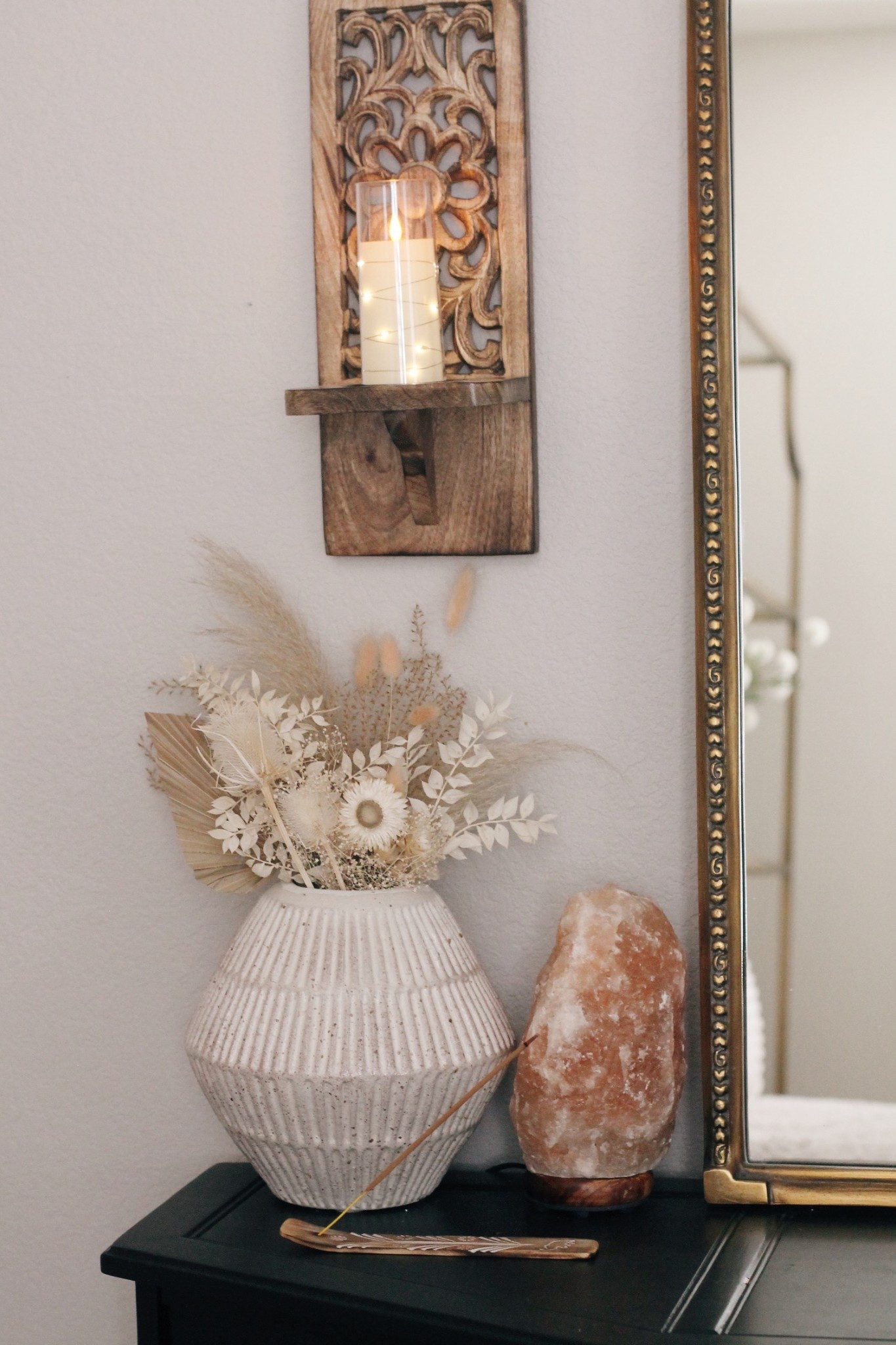 
Little ways I add calm and cozy to my bedroom space:  soft glow lighting with twinkle candles and a salt lamp + a lovely dried wildflower bundle + patchouli incense burning ✨ (one of my favs, smells soo good) 

My soft neutral bedroom corner styling with cozy, earthy vibes ✨ carved wood wall sconce with a glowing candle, a textured ceramic vase filled with dried florals and pampas grass, and a warm Himalayan salt lamp for that perfect ambient glow. Paired with a vintage-style mirror and burning patchouli incense, this space blends minimalist decor with a subtle boho touch; ideal for creating a peaceful, grounded home aesthetic.



#LTKHome