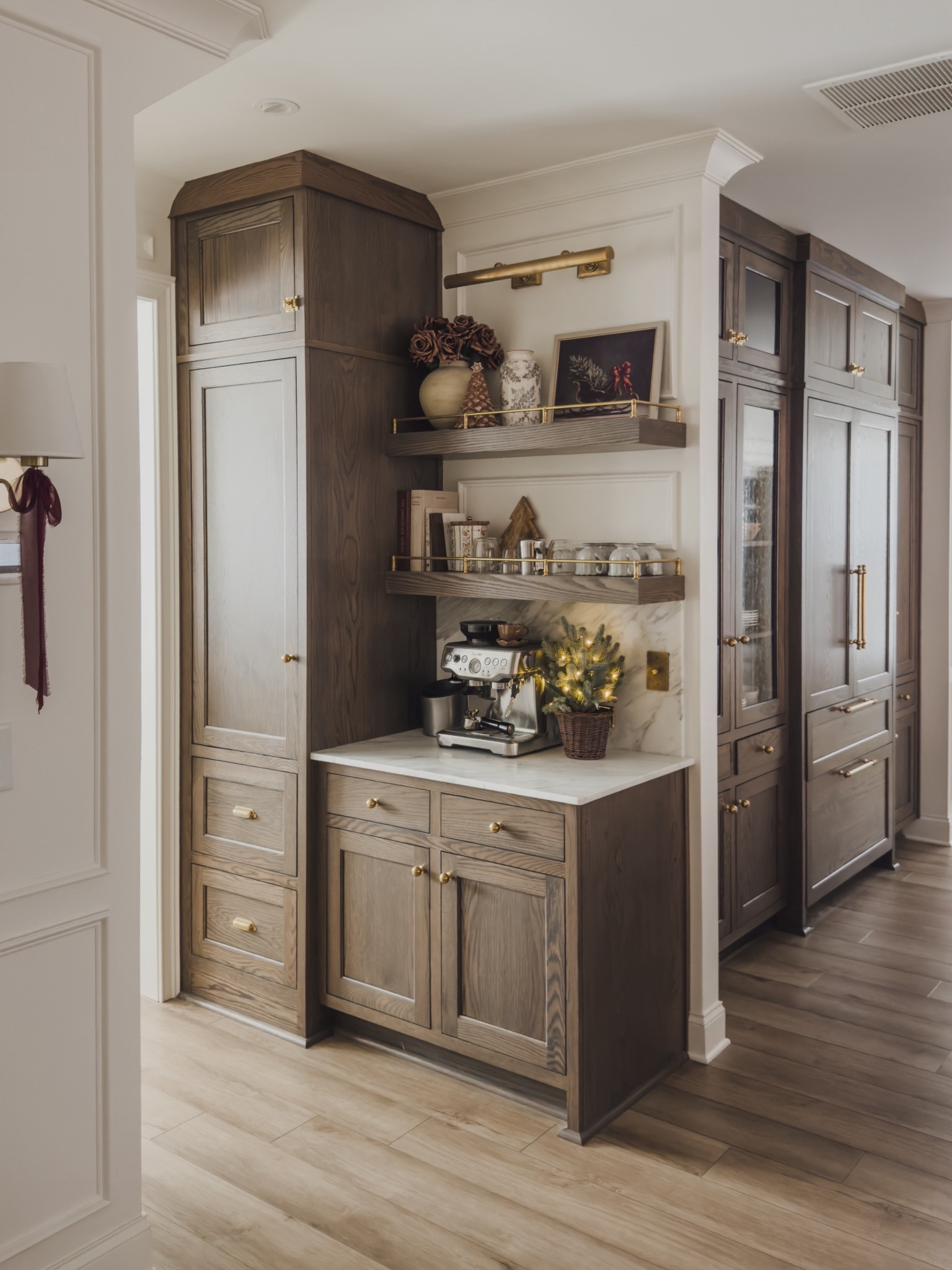 Cozy seasonal coffee bar views - keeping this space functional and aesthetic with a seasonal faux tree and pops of holiday decor.

Home finds, holiday views, coffee bar inspo, collected style, shelf style, rich wood tones, holiday home inspo, brass detail, lighting detail, cozy holiday, coffee station, faux florals, digital art, brass hardware, burgundy details, wall sconce, neutral decor book, picture light, Pottery Barn style, Rejuvenation, gingerbread details, shop the look!

#LTKSeasonal #LTKHome #LTKHoliday