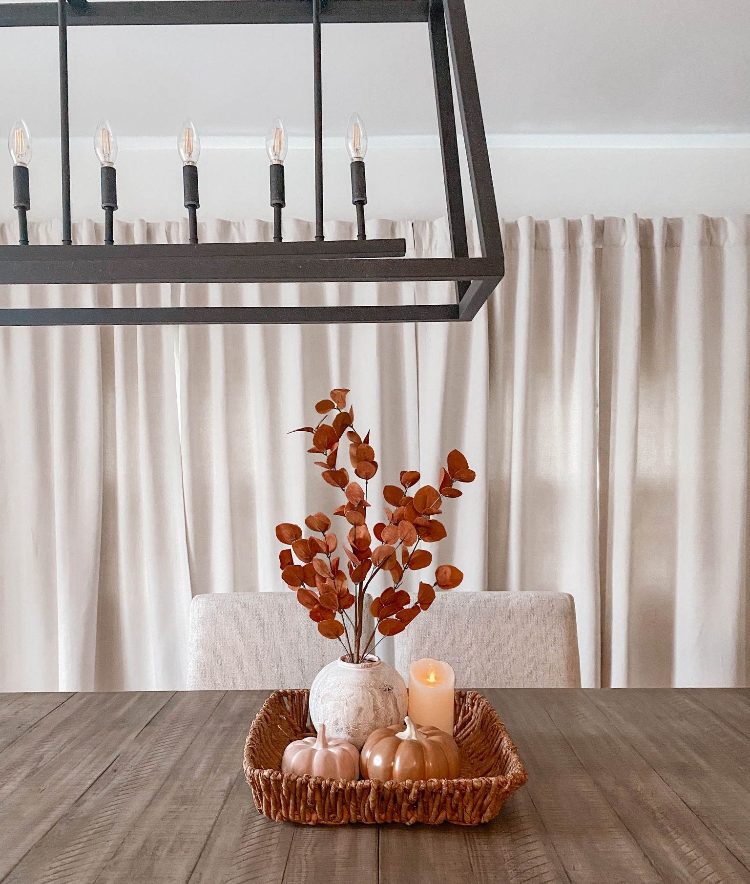 Dining room fall refresh 🍂 Love this autumn leaf stem and rustic vase from Kirklands. The modern black chandelier is also from Kirklands. These curtains from Amazon are my absolute favorite, we got the color birch. 

#diningtable #diningroom #homedecor #falldecor 

#LTKsalealert #LTKhome #LTKSeasonal