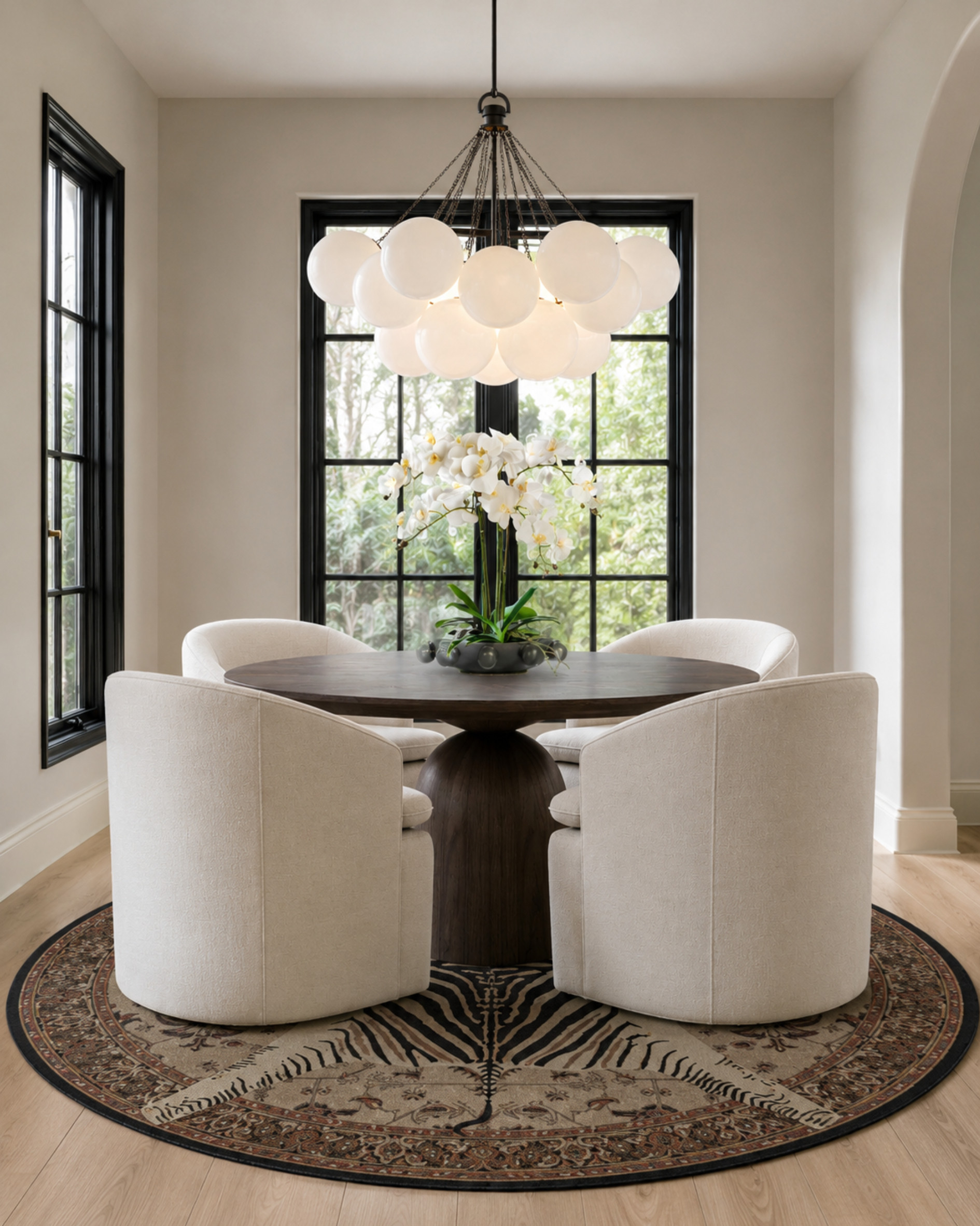 This dining nook feels so rich because of the contrast: creamy curved chairs, a dark wood pedestal table, black window trim, a statement globe chandelier, and a patterned round rug that grounds the whole space. Soft, classic, and a little unexpected.

I may receive a commission from items purchased through my links. 

 #LTKHome
