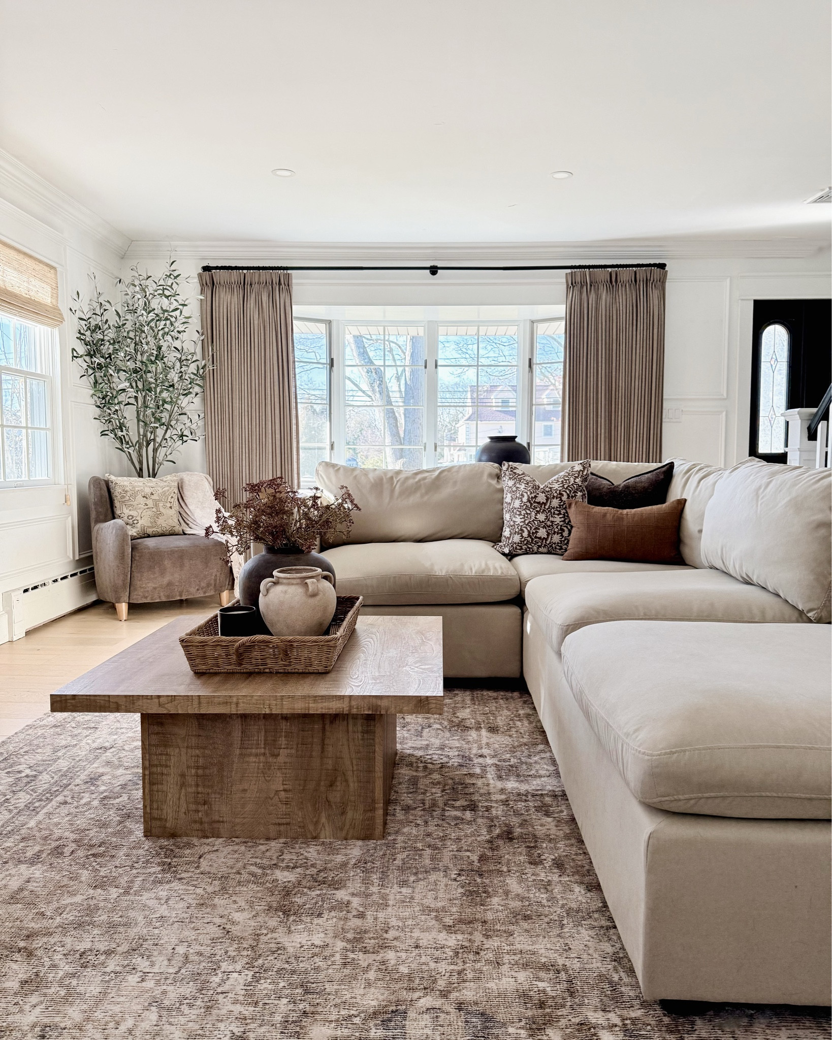 SWIPE FOR MORE: This is what I call cozy, collected, and lived-in. 🤎 We refreshed our living room for the New Year by rearranging our sofas into one sectional, added new pillows, coffee table decor, and a new cabinet that I’m obsessed with.  

neutral decor | cozy | organic modern | area rug | drapes | chair | vase | gallery frames

#LTKSaleAlert #LTKHome #LTKdayinmylife