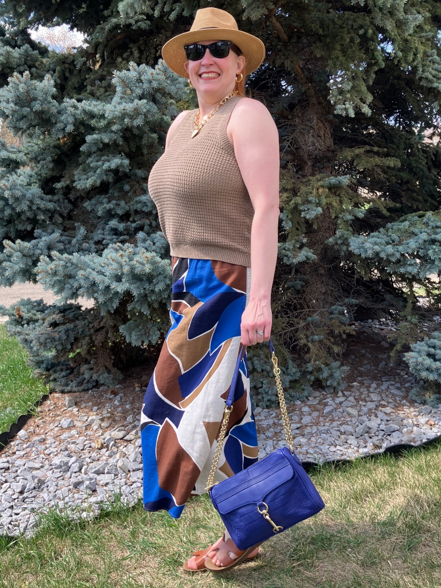 The sun always shines on TV but not always when I take a photo! 😮‍💨 But here is my look for today. I wore this skirt before as a dress but now I’ve styled it with a cute hat, sunnies, chunky heart necklace knitted tank top, neutral slides, and a bright blue bag. Buying more isn’t the answer. Finding ways to wear what you have in different ways is! Canadians click on the first links to shop, and Americans click on the second links to shop. If there’s only one link then you can shop it in your own country. And remember, trendy doesn’t have to be expensive! Bye!

#LTKsummer #LTKmidsize #LTKover50style
