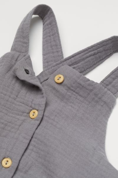 Baby Exclusive. Romper suit in woven, crinkled organic cotton fabric. Buttons at front, shoulder ... | H&M (US + CA)