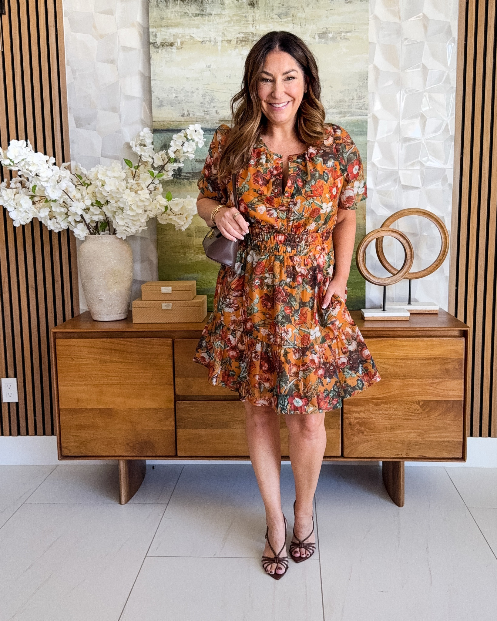 @athropologie Fall floral mini dress 🍂 Rust orange floral print short-sleeve mini dress with a smocked waist and flowy tiered skirt, styled with a brown mini bag and burgundy strappy heels. A pretty date-night and fall wedding guest dress in warm autumn tones.

Sizing: true to size, large

#LTKSeasonal #LTKOver40 #LTKMidsize