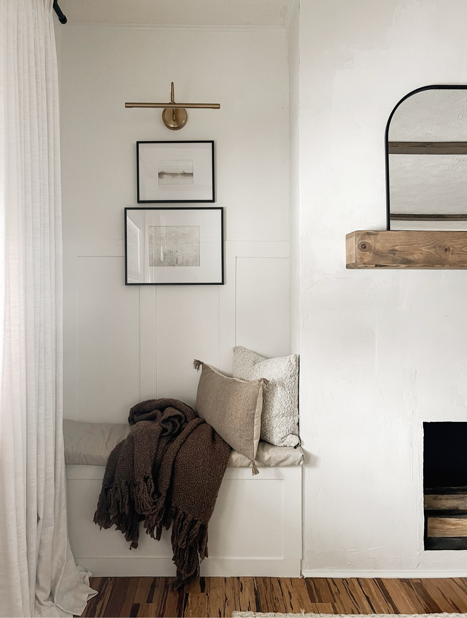 living room built-in nook. this cozy little bench! top art is a digital download you print + frame i use kinkos or mpix! the bottom i painted. 

Home decor. Art. Wall art. Picture light. Throw pillows. Brown blanket. Throw blanket. Arch mirror. Digital art. Winter decor  

#LTKfindsunder50 #LTKhome #LTKsalealert