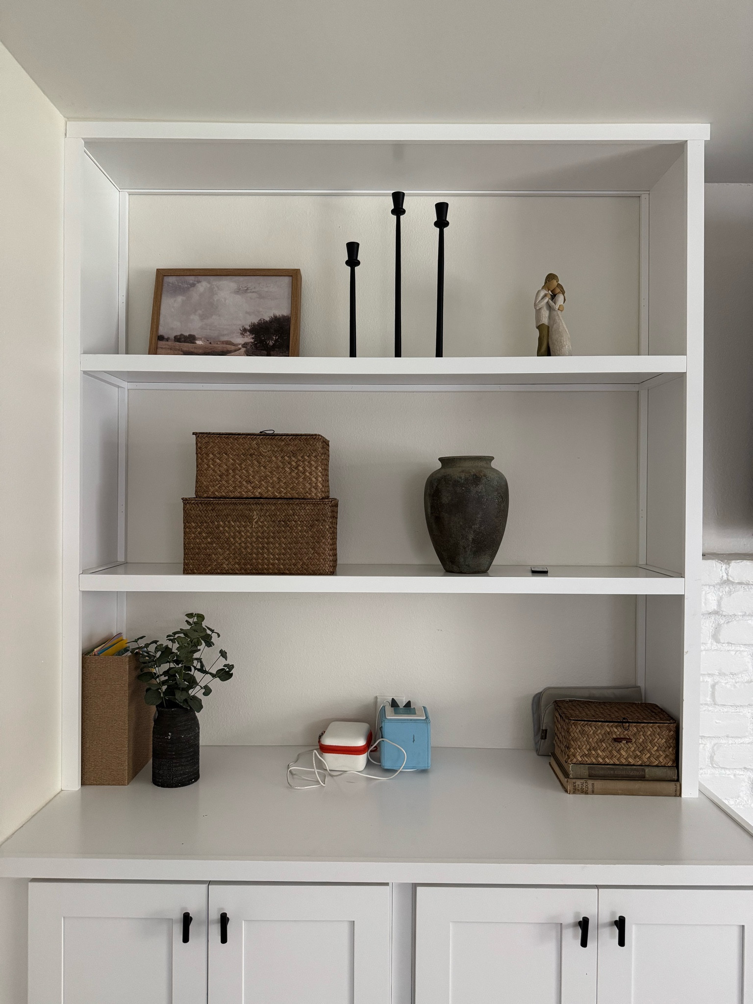 Traditional shelf styling in the living room/playing room. Top shelf: Home Goods & the couple was gifted. Middle shelf: bins linked (set of 3, third is bottom right), vase is Hobby Lobby. Black planter is Hobby Lobby and file holder is Target. Books are a hand me down. 

#LTKHome