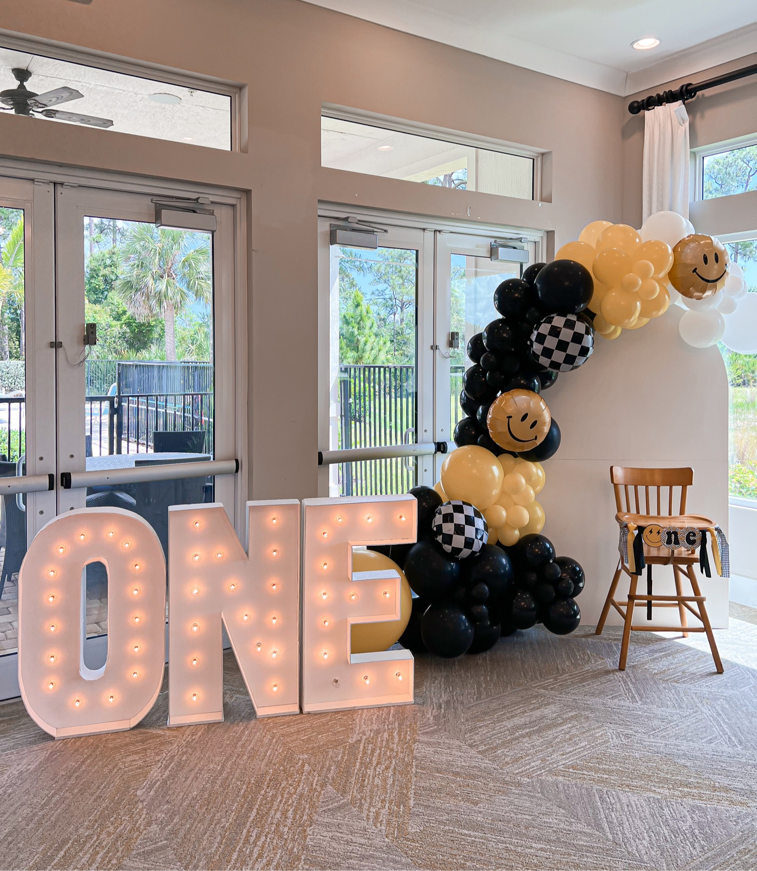 Photo & highchair backdrop! 
-I did not make my own ballon arch this time, we used a local company Blue Lime Events & added the ONE giant light sign. 

-Aarons dad made the wooden arch backdrop do us. It folds down down for easy storage so we can use in the future, I will have those plans linked as well as a DYI ballon arch link!  