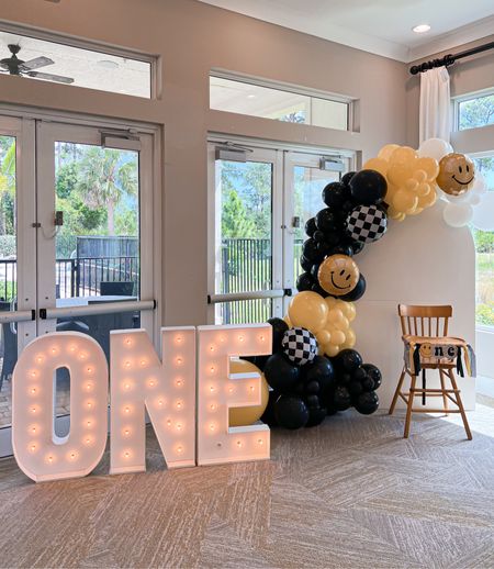 Photo & highchair backdrop! 
-I did not make my own ballon arch this time, we used a local company Blue Lime Events & added the ONE giant light sign. 

-Aarons dad made the wooden arch backdrop do us. It folds down down for easy storage so we can use in the future, I will have those plans linked as well as a DYI ballon arch link!  