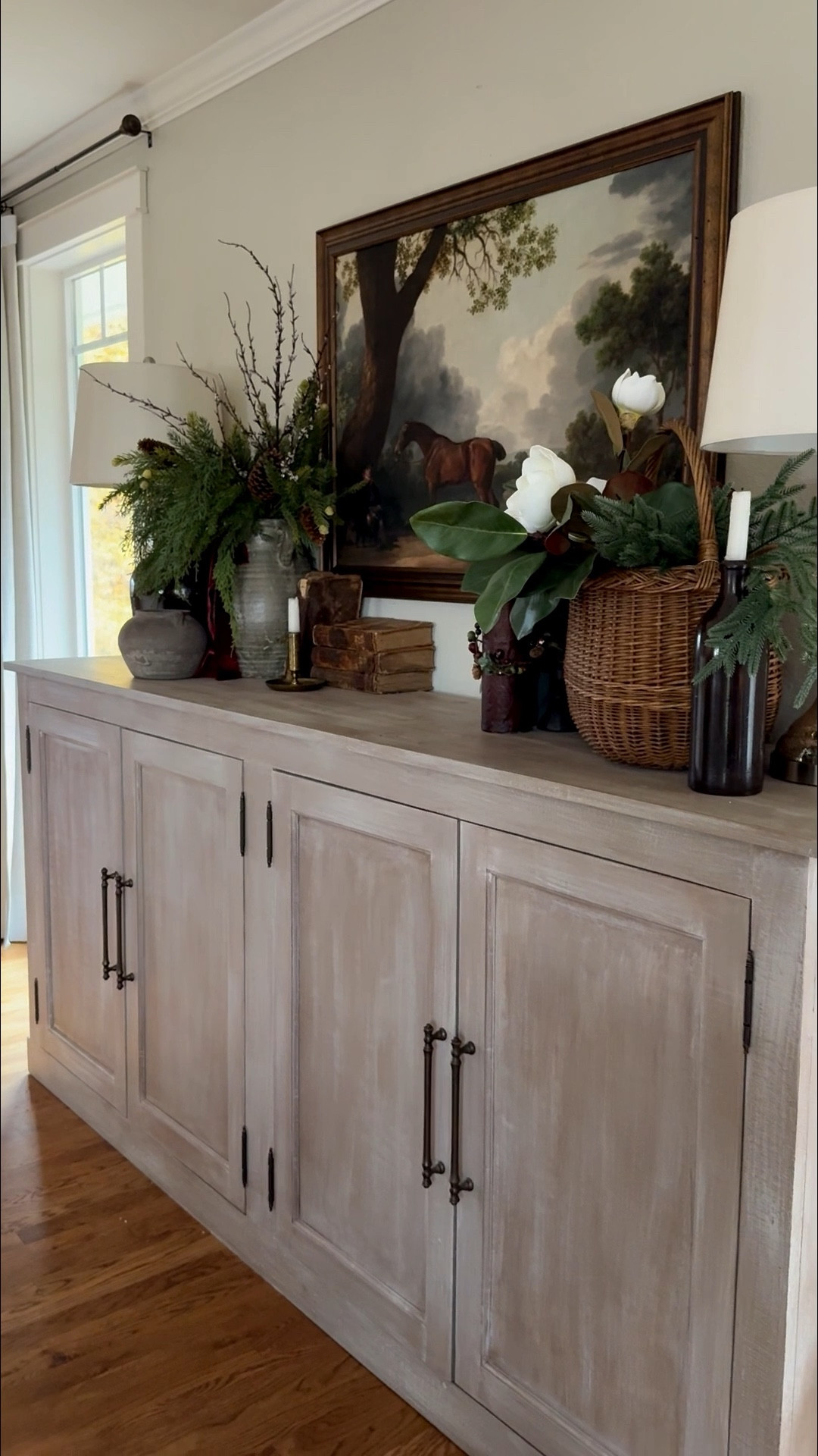 ✨ Old World European Farmhouse Winter Sideboard ✨
This winter, my sideboard is styled with the warmth and character of an Old World European farmhouse—where every piece tells a story. A vintage equestrian print anchors the space, adding that timeless, heritage feel reminiscent of classic European manors.
I layered in aged crocks and weathered pottery, their patina and imperfections lending authentic, collected charm. A realistic green garland, with the look of freshly gathered winter clippings and icy twigs, weaves through the display, softening the aged textures with a touch of natural beauty.
Vintage French baskets, timeworn books with tattered covers, and a few fading magnolia stems complete the look—each detail evoking the feeling of a storied home where history meets quiet elegance.
This European farmhouse sideboard styling blends old-world sophistication with rustic warmth, creating a collected, soulful winter look that feels both refined and inviting.

#LTKHome #LTKHoliday #LTKSeasonal