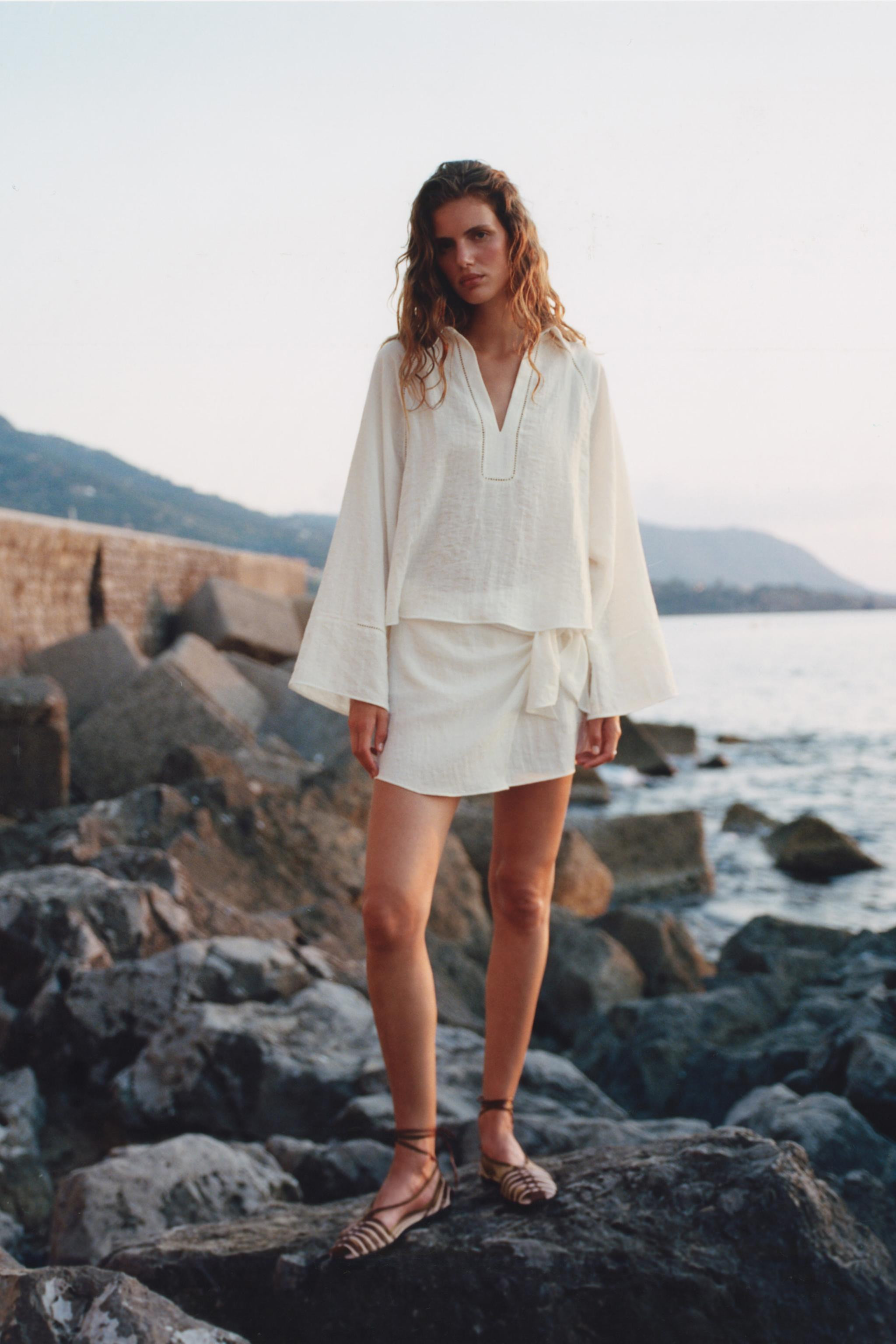 Shirt with a regular collar, V-neck and wide long sleeves. Matching lace trim detail. Front faste... | Zara UK