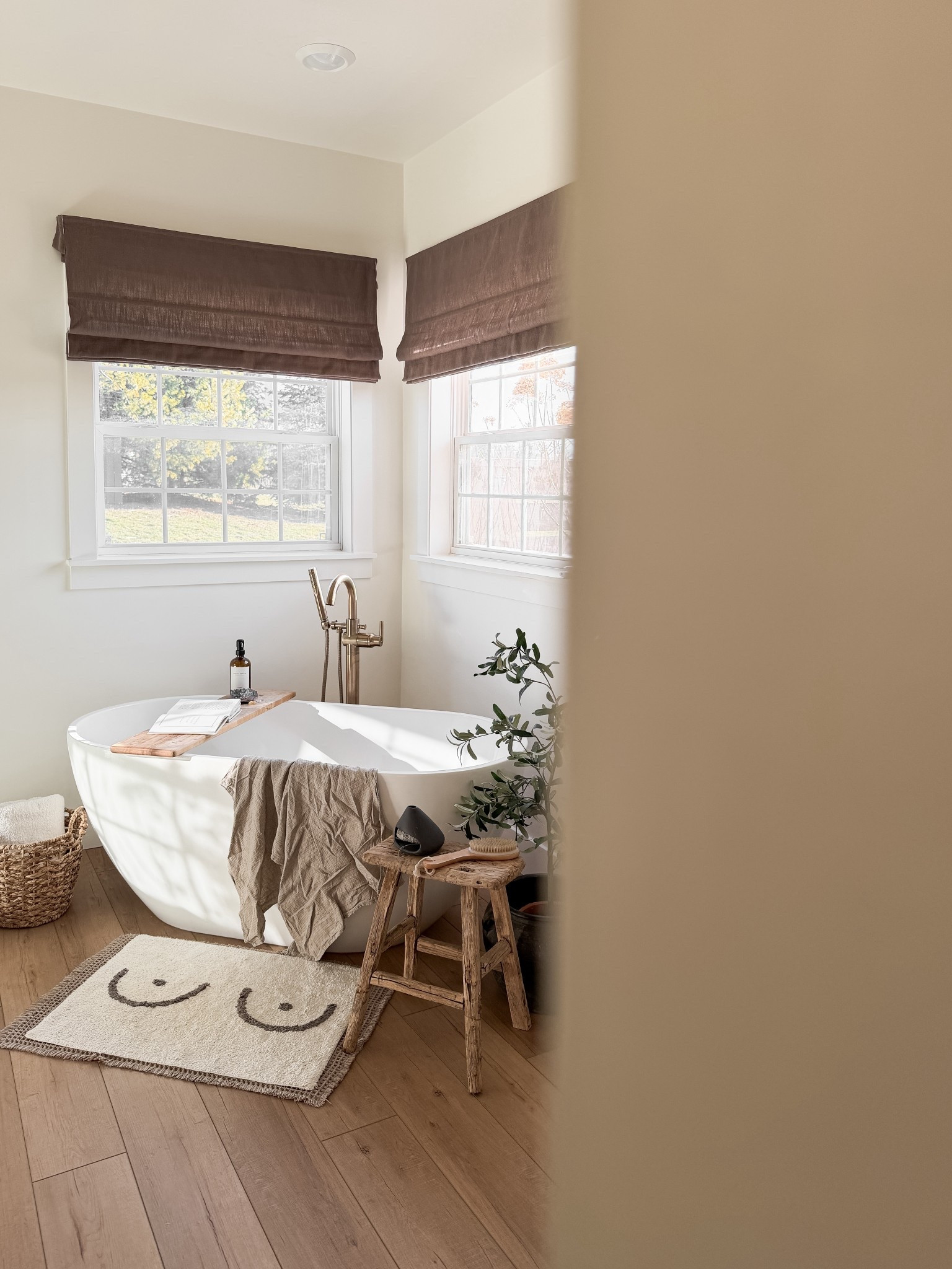 The warm wood tones, the linen textures, the way the light comes in… it’s one of my favourite little corners of our home.

I’ve linked everything I could find to recreate this cozy, organic look from the roman shades to the bath stool, tub tray, and those little details that make it feel finished.

#LTKhome #LTKstyletip #LTKsale