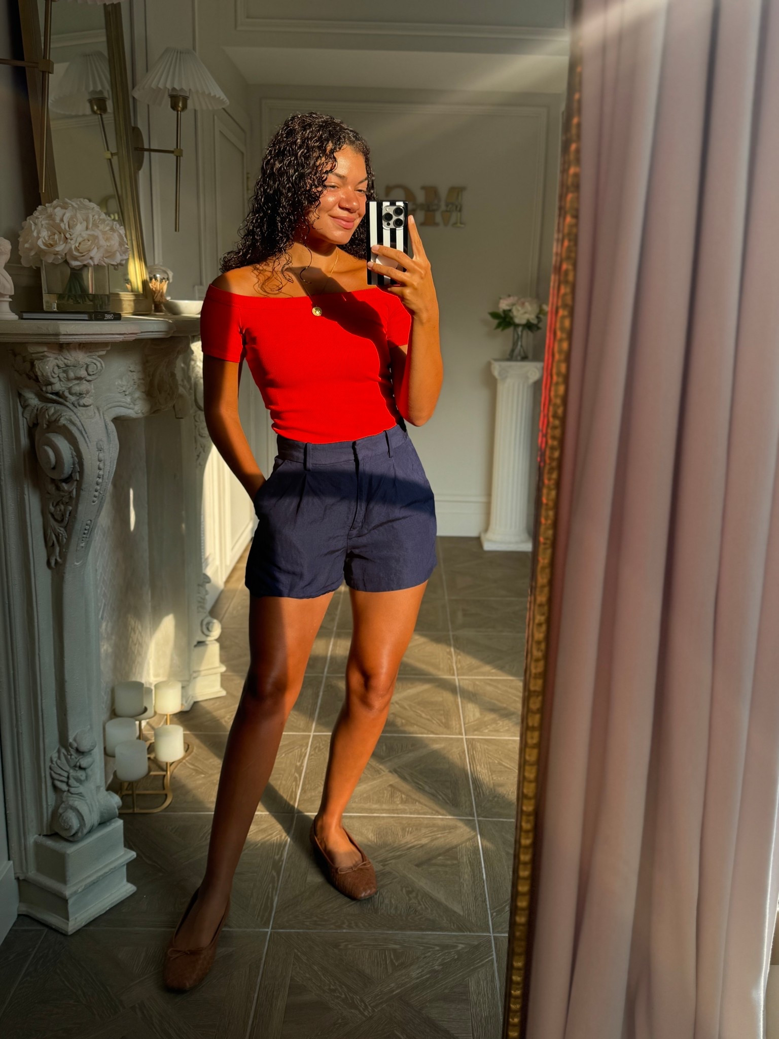 An orange red off the shoulder top paired with high waist navy blue shorts, gold accessories, and brown woven flats 

#LTKStyleTip #LTKSeasonal