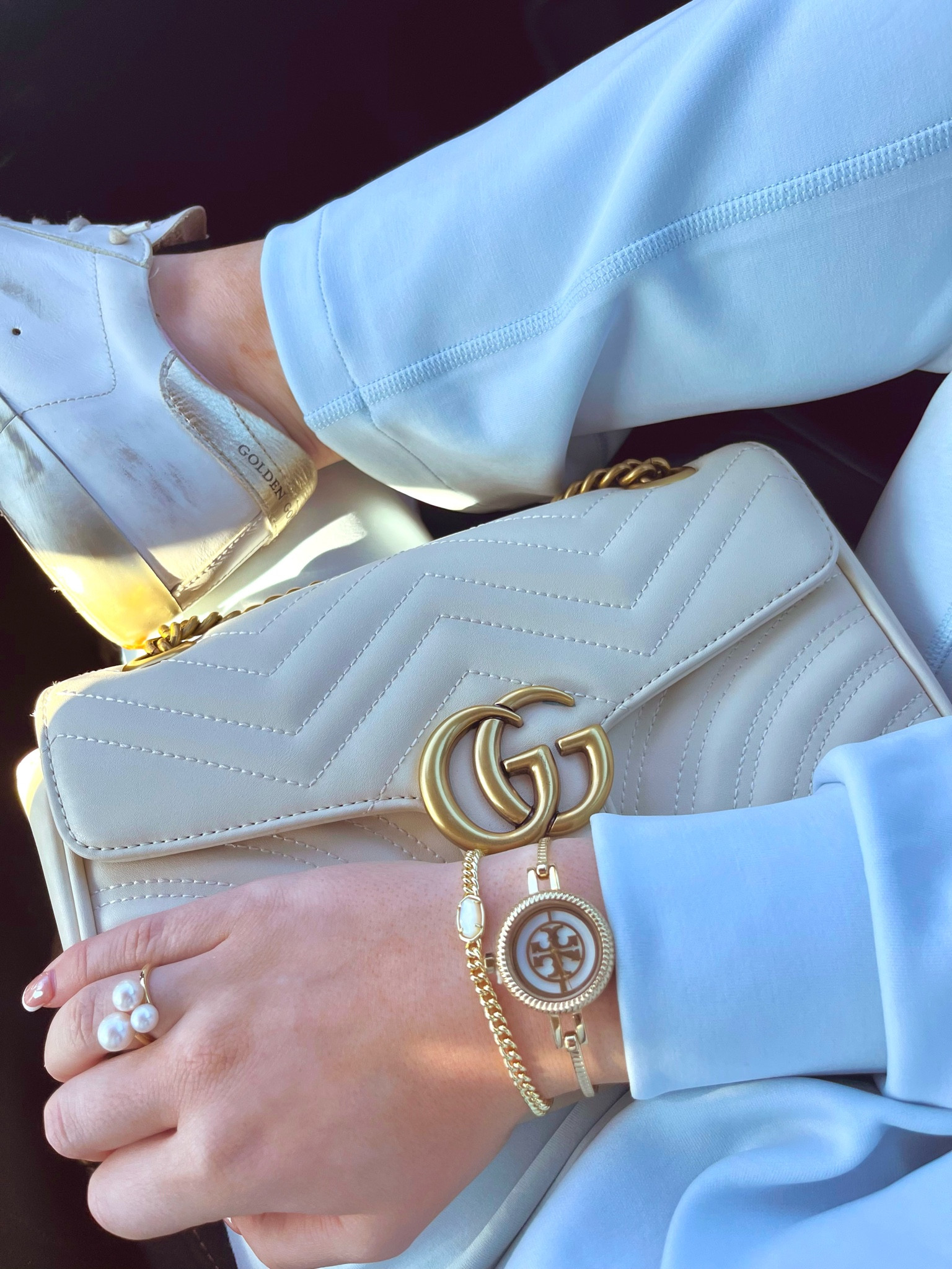FAVORITE WATCH EVER🙌🏼 tory burch bezel watch, gold dainty bangle watch, kendra scott chain bracelet, pearl ring, gucci white leather marmont bag, golden goose super star, ootd

#LTKstyletip #LTKHoliday #LTKGiftGuide