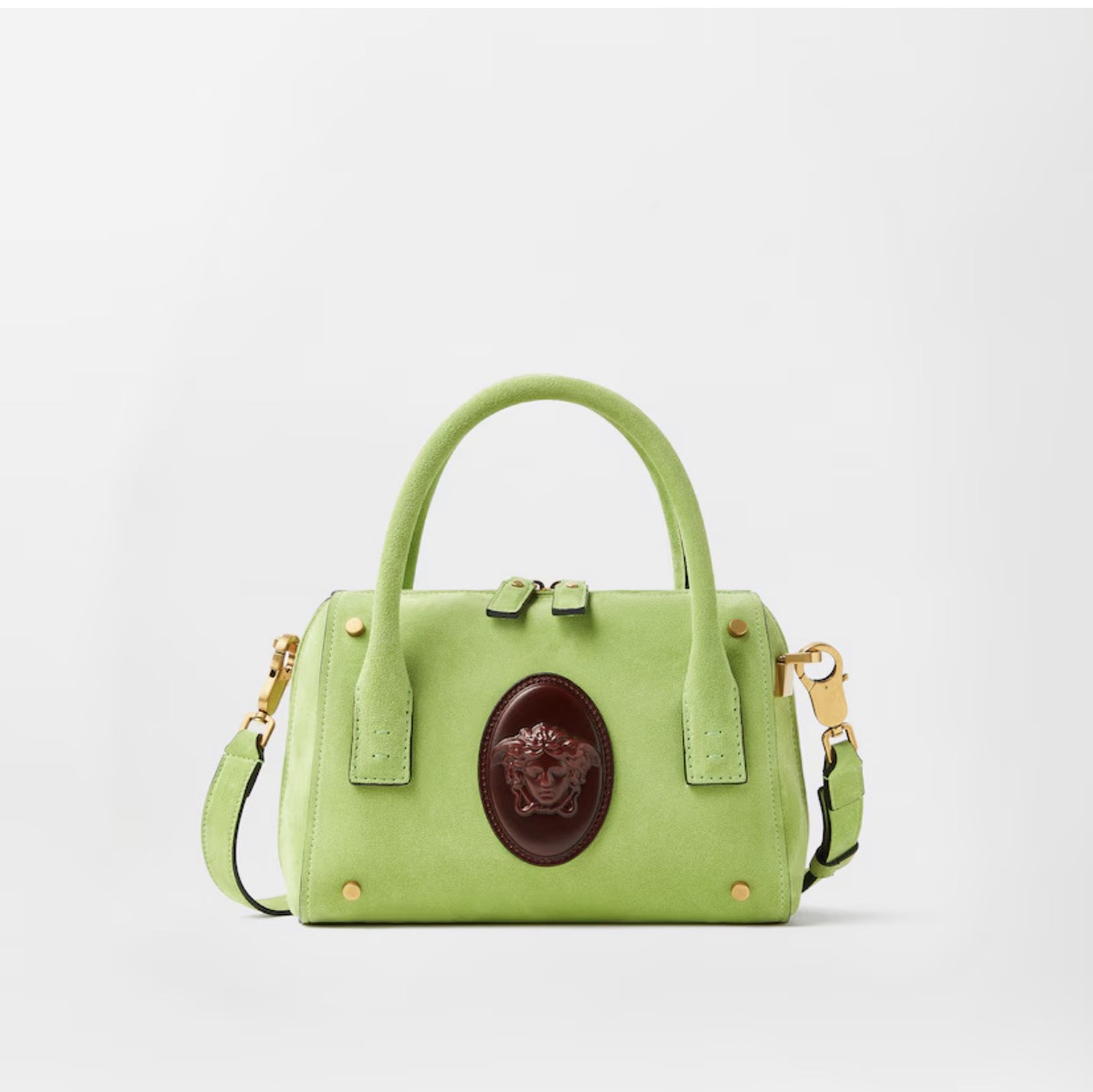 This small Roomy Boston bag is crafted from suede leather, defined by a central Medusa Cameo leather patch—a 3D rendition which captures the depth of Medusa's eyes and winged details in her hair. The design is contrasted with metal rivets, and can be carried in-hand or crossbody using the detachable shoulder strap.
Medusa Cameo leather patch
Top handles
Detachable and adjustable shoulder strap
Two-way zip-around closure
1 interior slip pocket
Outer composition: 100% Calf leather
Lining: 59% Linen, 41% Cotton
Trim: 100% Calf leather
Size & Fit
L9.1 x W4.3 x H6.3" / L23 x W11 x H16 cm
Handle drop: L3.1" / L8 cm
Shoulder strap: L48.4" / L123 cm
Shoulder strap drop: L22.8" / L58 cm

#LTKSaleAlert #LTKdayinmylife #LTKU