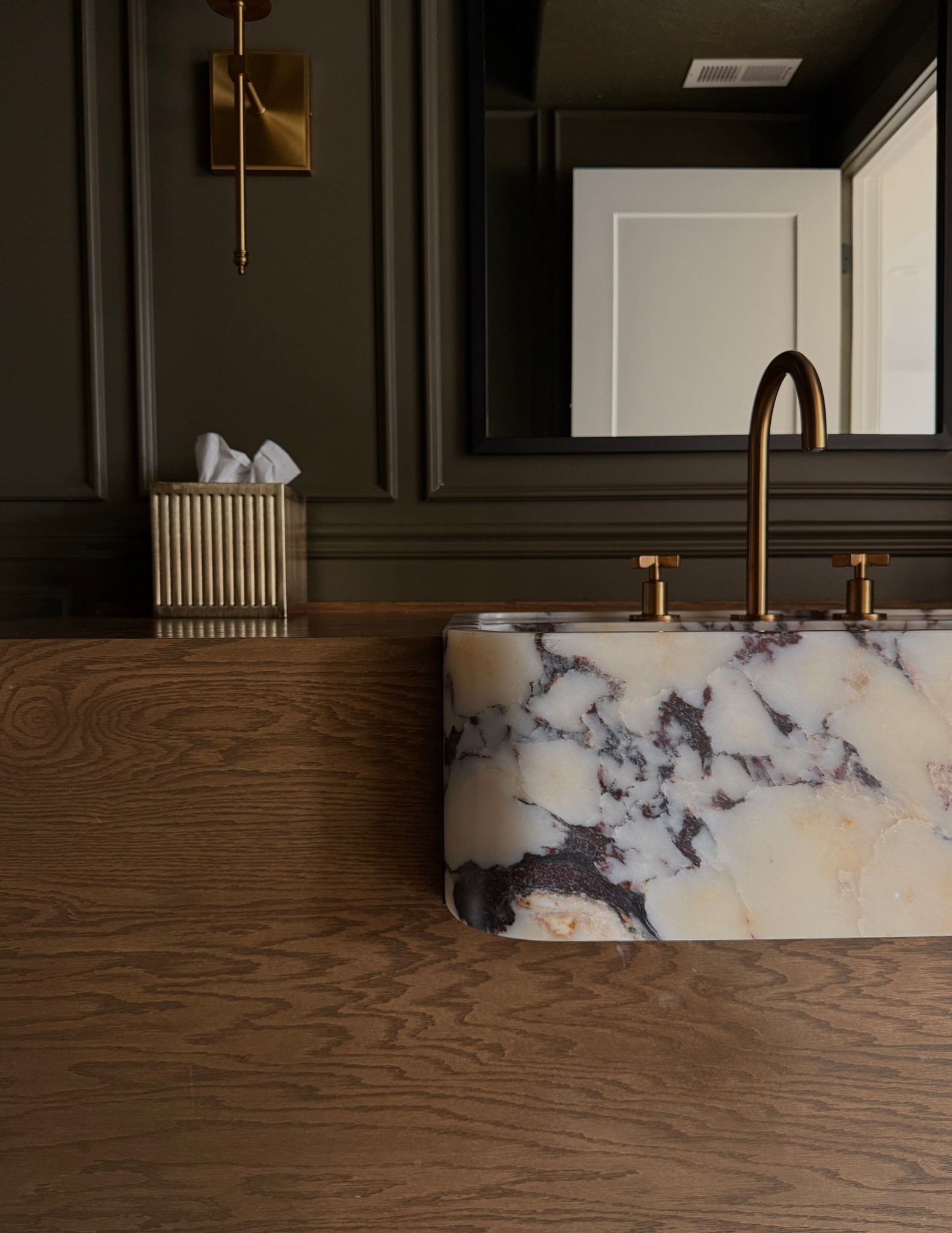 Viola marble front apron bathroom sink.
Wall sconces 
Wide spread gold faucet 
Arch round top black framed mirror
Wall switch plate 
Furniture feet
Gold Kleenex cover

#LTKselfcare #LTKgrwm #LTKHome