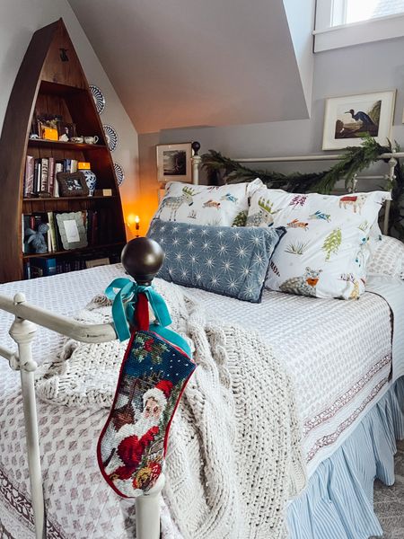 Whimsical Christmas decorated bed — stocking hung on footboard and boat bookcase  

#LTKHoliday #LTKhome #LTKSeasonal