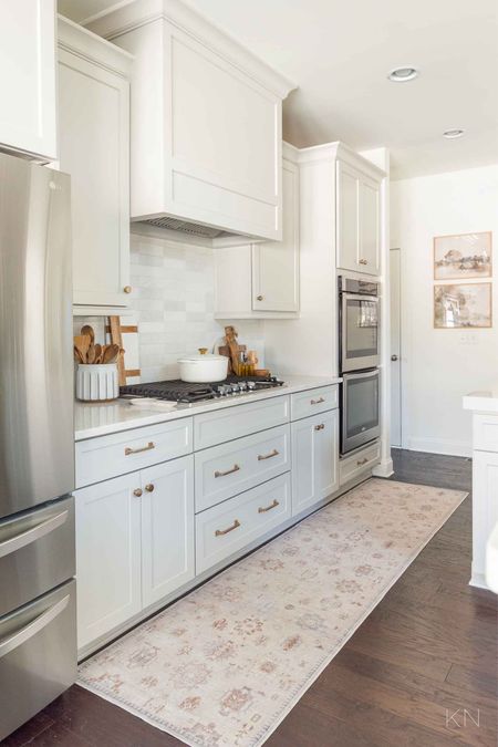 One of my favorite makeovers in the last year was my kitchen redo, where I repainted the walls, added white tiled backsplash and switched out the cabinet doors, hardware and color to Agreeable Gray. home decor kitchen decor neutral kitchen runner kitchen art champagne bronze cabinet pulls

#LTKhome #LTKstyletip