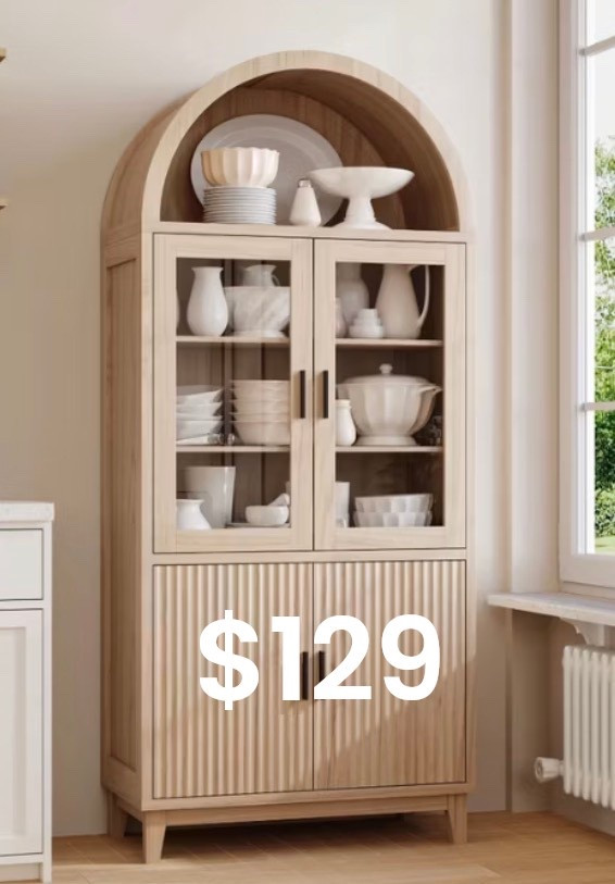 
A serene, light-filled interior featuring a tall arched light-oak cabinet with glass doors and fluted wood detailing on the lower panels. Shelves are styled with layered white ceramics, bowls, and sculptural pottery, creating a calm, curated look. Soft natural daylight streams through a nearby window, highlighting warm wood tones, subtle shadows, and organic textures. Modern European farmhouse aesthetic, quiet luxury styling, timeless design, ultra-realistic editorial interior photography.

⸻

Hashtags (25)

#ArchedCabinet
#NeutralHome
#OrganicModern
#QuietLuxuryHome
#EuropeanInspired
#WarmWoodTones
#TimelessInteriors
#StyledShelves
#NeutralDecor
#MinimalLuxury
#ModernTraditional
#HomeInspo
#InteriorAesthetic
#CalmLiving
#ArchitecturalDetails
#SoftNeutrals
#OrganicTextures
#ElevatedInteriors
#HomeEdit
#ModernFarmhouse
#InteriorStyling
#DesignInspiration
#CozyMinimal
#NaturalMaterials
#EffortlessStyle



#LTKHoliday #LTKGiftGuide #LTKdayinmylife