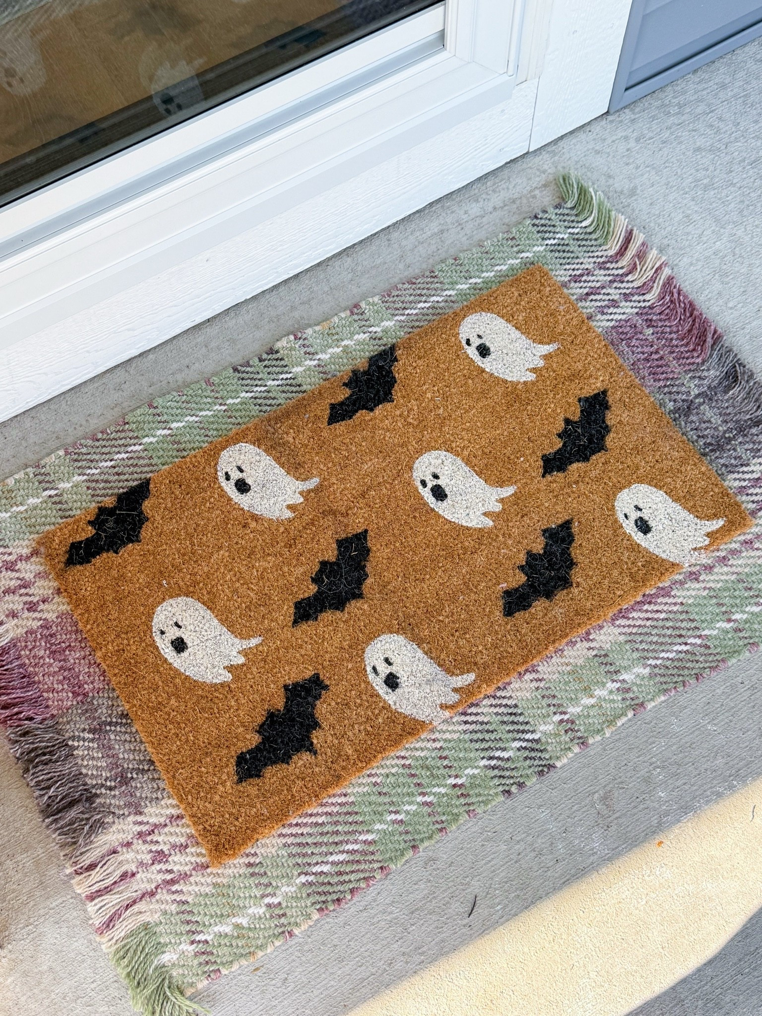 Fall front porch from Walmart / layered the plaid rug with the cute little ghosts and bag rug

#LTKHome #LTKSeasonal