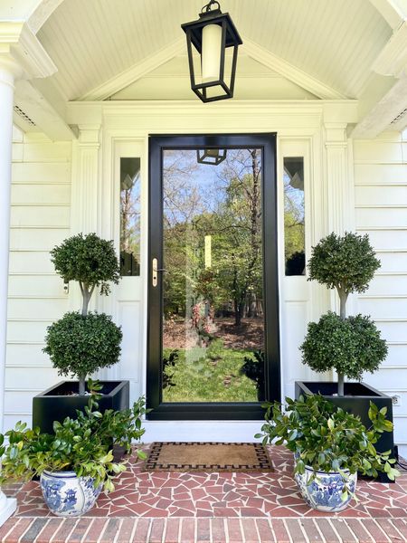 Traditional front porch, outdoor decor, topiaries, blue and white planter, lantern, pendant, light, Greek key doormat

#LTKhome #LTKSeasonal