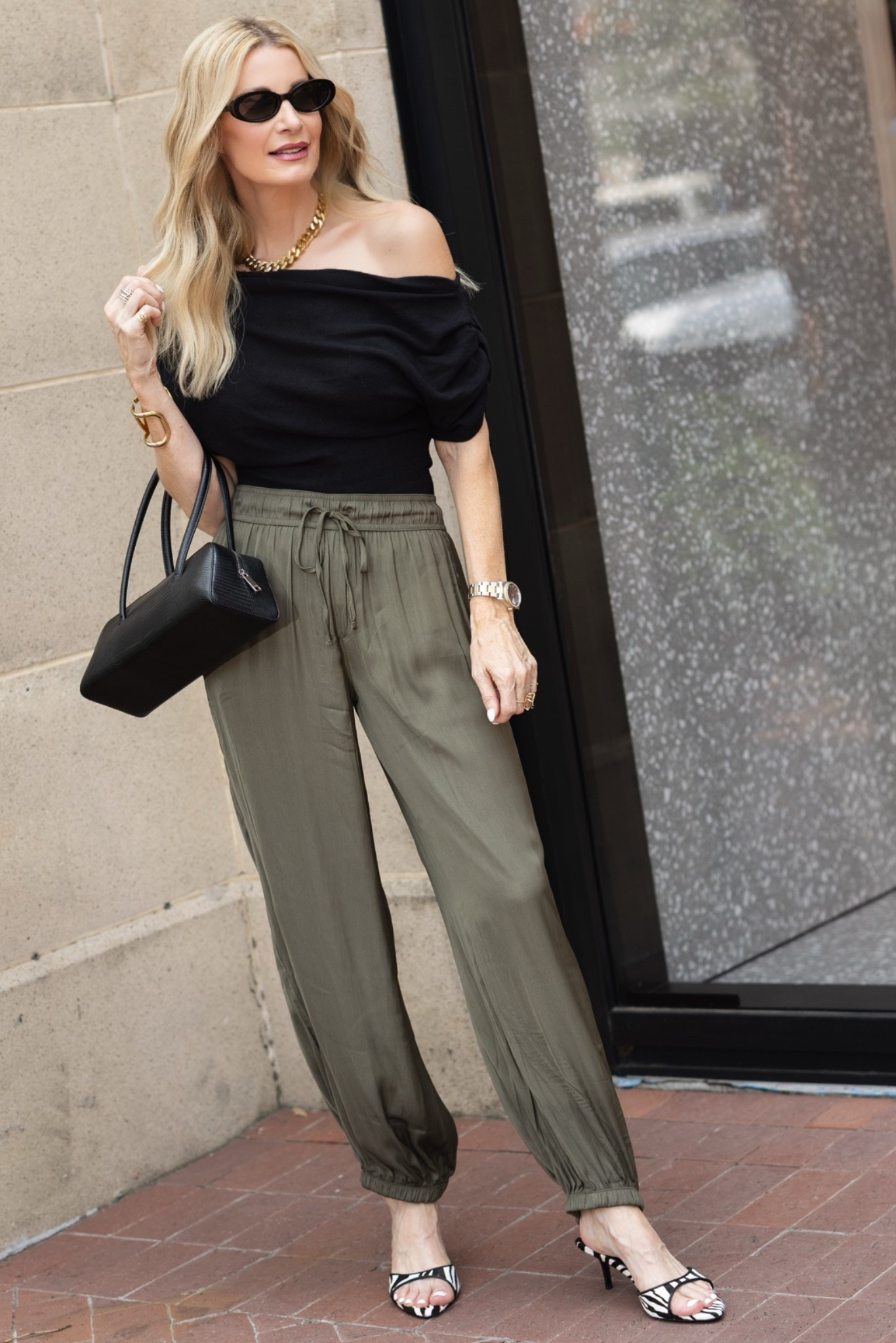 The perfect chic night-out look! This elegant black off-the-shoulder top paired with silky olive jogger pants feels effortlessly elevated and incredibly flattering. I’m wearing an XS in the top and pants. #LTKOver40 #LTKDateNight #LTKStyleTip 

 