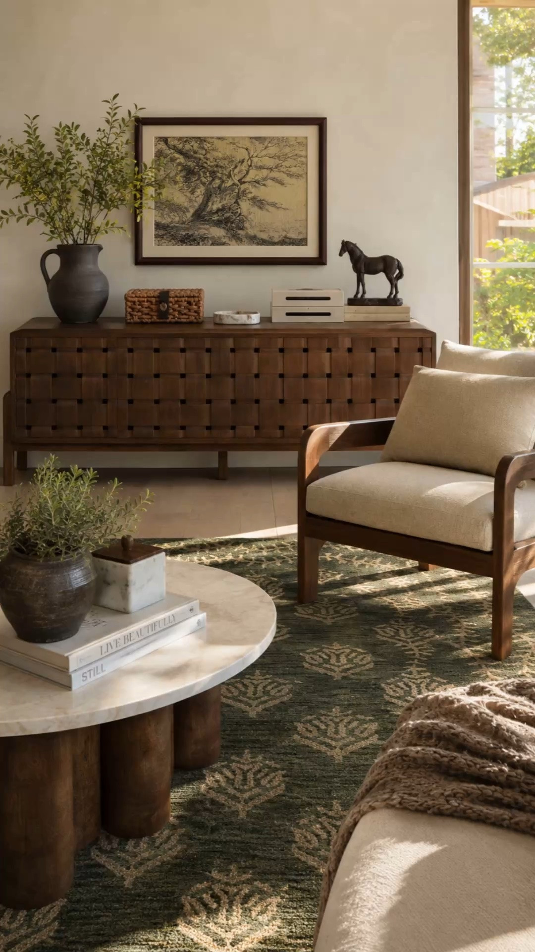 That rug and woven wood console are doing all the heavy lifting here 🤎🌿

Proof that a few thoughtfully chosen pieces can completely transform a room. Rich wood tones, vintage-inspired details, cozy textures, and a touch of green create that collected-over-time look that never goes out of style.

This is the kind of space that makes you want to slow down, light a candle, and stay awhile.

#LTKHome #LTKSeasonal #LTKSaleAlert