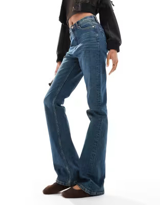 ASOS DESIGN Tall mid rise flare jeans in dark tinted blue | ASOS (Global)