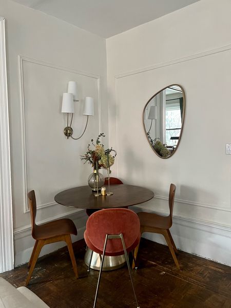 Dining room, furniture, and decor. Round pedestal, dining table, wood and gold, asymmetrical mirror, upholstered, velvet, dining chair, wood, dining chair, three arm, scones, salt, and pepper, shakers, gold candle stick

#LTKstyletip #LTKhome #LTKFind