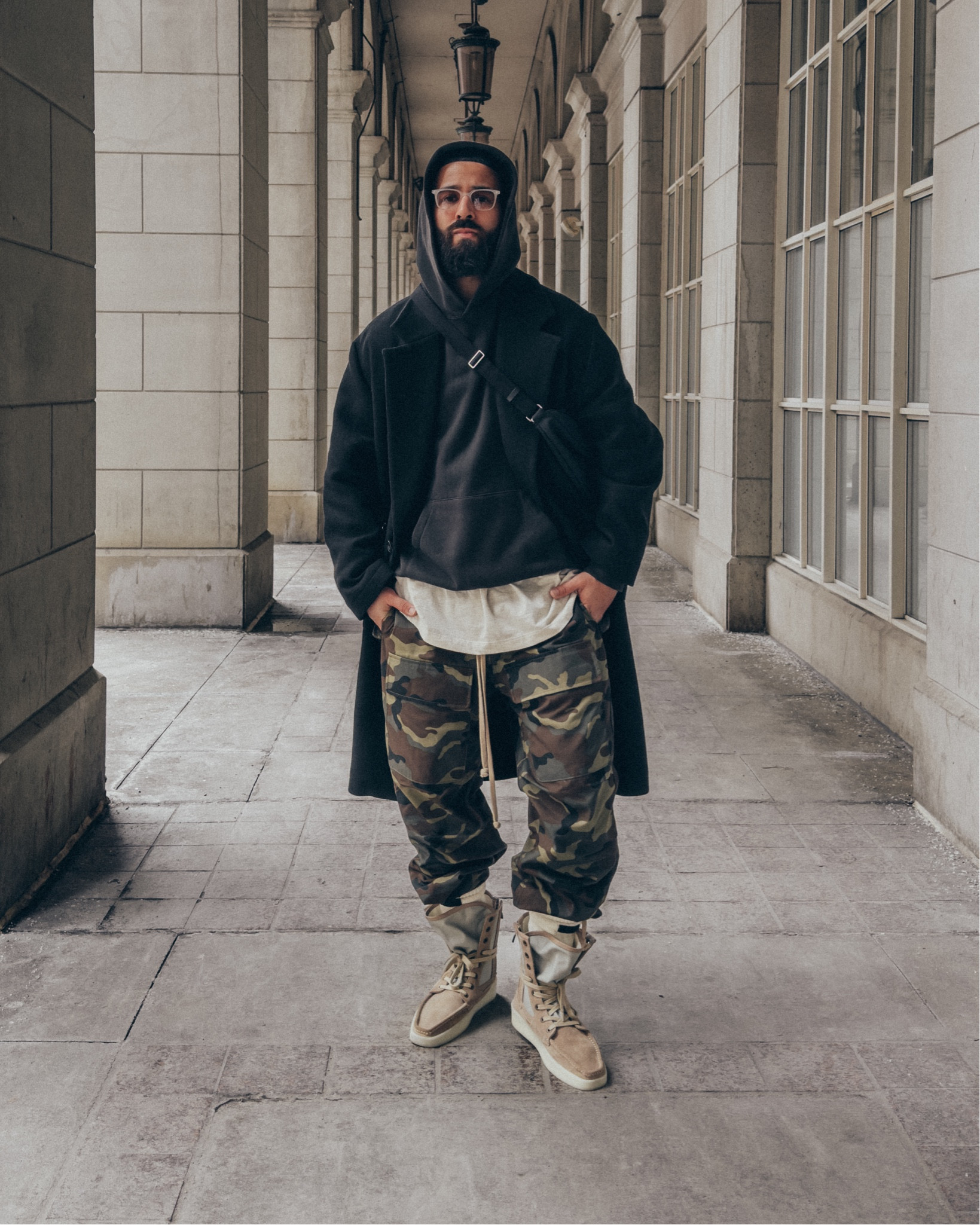 ESSENTIALS Hoodie in ‘Black’ (size M). FEAR OF GOD Allstars Henley tee in ‘Vintage White’ (size M), Cargo pants in ‘Camo’ (size S), and Boat-Hi boots in ‘Daino’ (size 41). FEAR OF GOD x BARTON PERREIRA glasses. THE ROW Slouchy Banana Bag in ‘Black’. A relaxed and elevated men’s outfit that’s layered to keep you warm through the Spring. 

#LTKmens #LTKstyletip