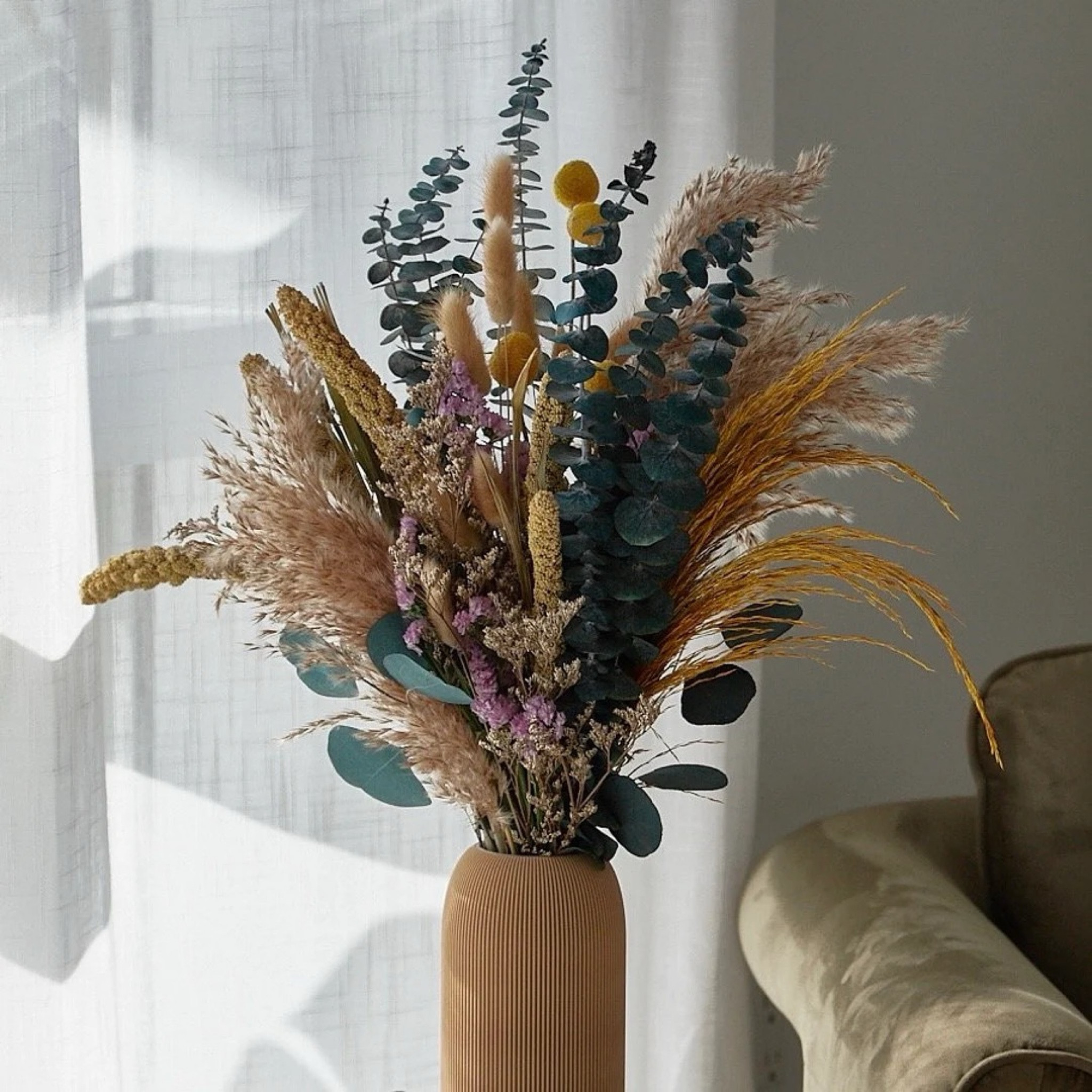This Le Jardin dried bouquet is the perfect blend of earthy and serene, featuring pampas grass, billy balls, bunny tails, millet, statice, and preserved eucalyptus in a stunning mix of brown, blue, and golden tones. The thoughtfully balanced textures and soft color palette make it a standout piece for styling shelves, consoles, or dining spaces—adding warmth and elegance without any maintenance. Designed to last for over a year, it’s a timeless decor staple or an effortless gift that feels both elevated and natural. #ltkhome #ltkdecor #driedflowers #pampasgrass #bohodecor #neutralstyle #homestyling #cozyhome #sustainabledecor

#LTKSeasonal #LTKHome #LTKWedding
